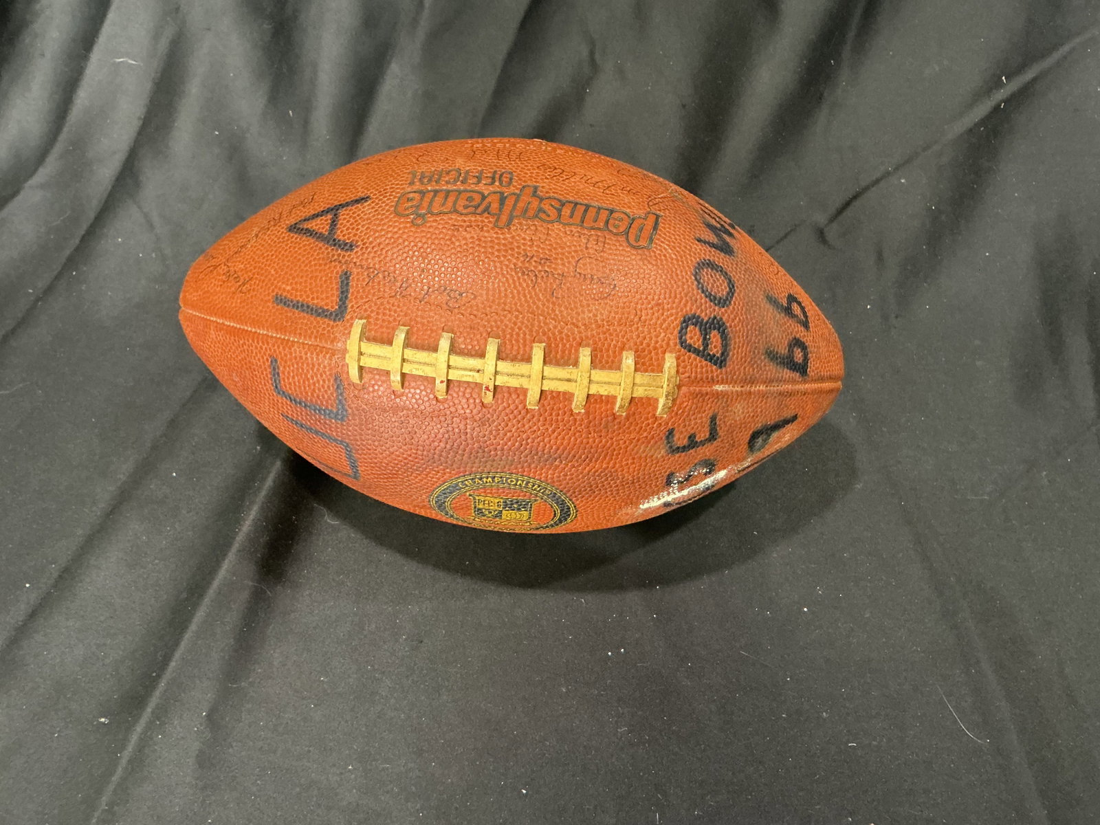 Vintage Multi-Signed 1966 Rose Bowl Football: Vintage Pennsylvania Official leather football marked UCLA Rose Bowl 1966 and featuring numerous player and staff signatures from the UCLA team. Strong college football display piece tied to the 1966