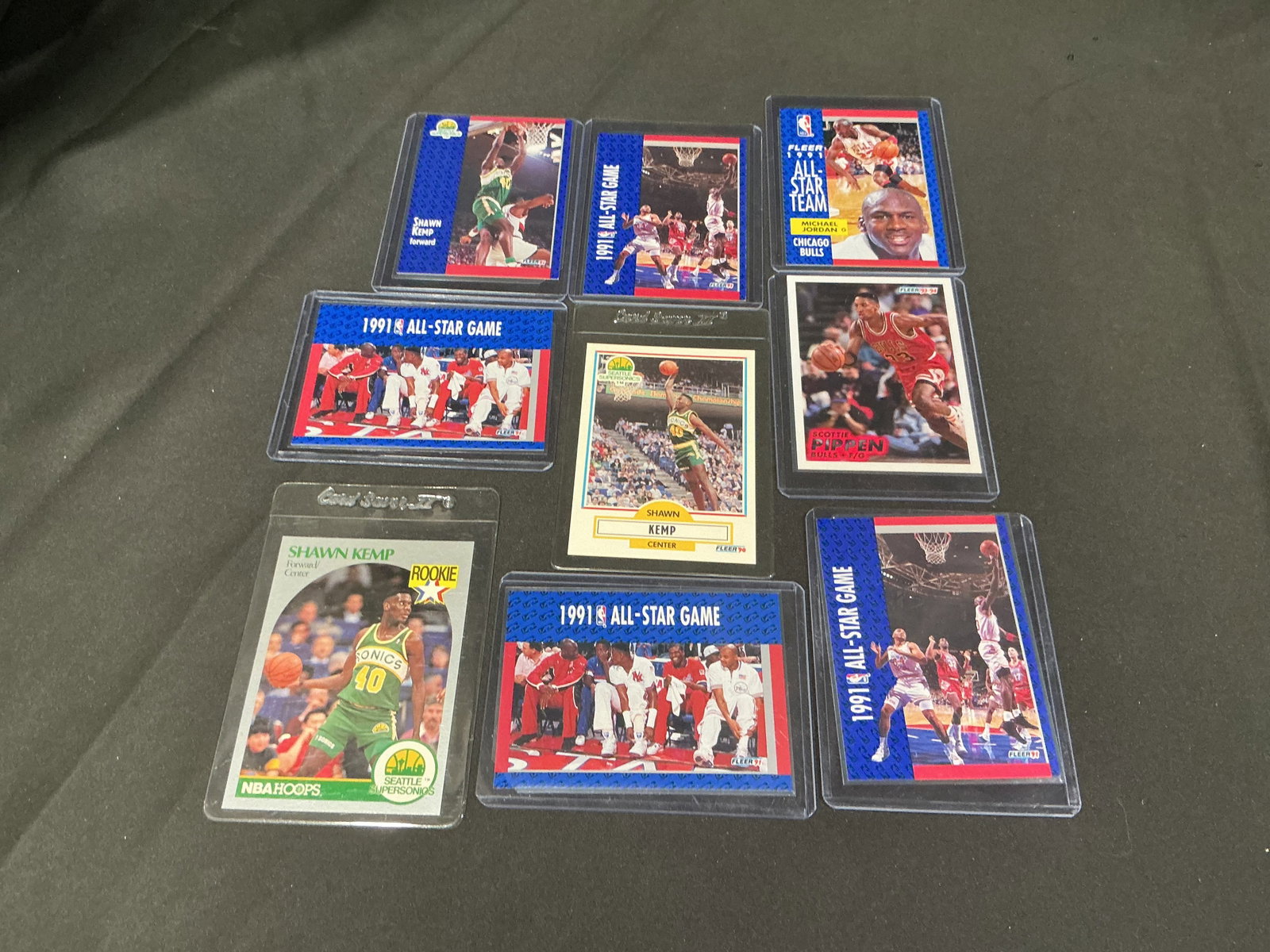 Michael Jordan, Pippen & Shawn Kemp Cards: Mixed basketball card lot featuring Michael Jordan, Scottie Pippen, and Shawn Kemp cards from the early 1990s collecting era. Includes Michael Jordan 1991 Fleer All-Star Team card, Scottie Pippen