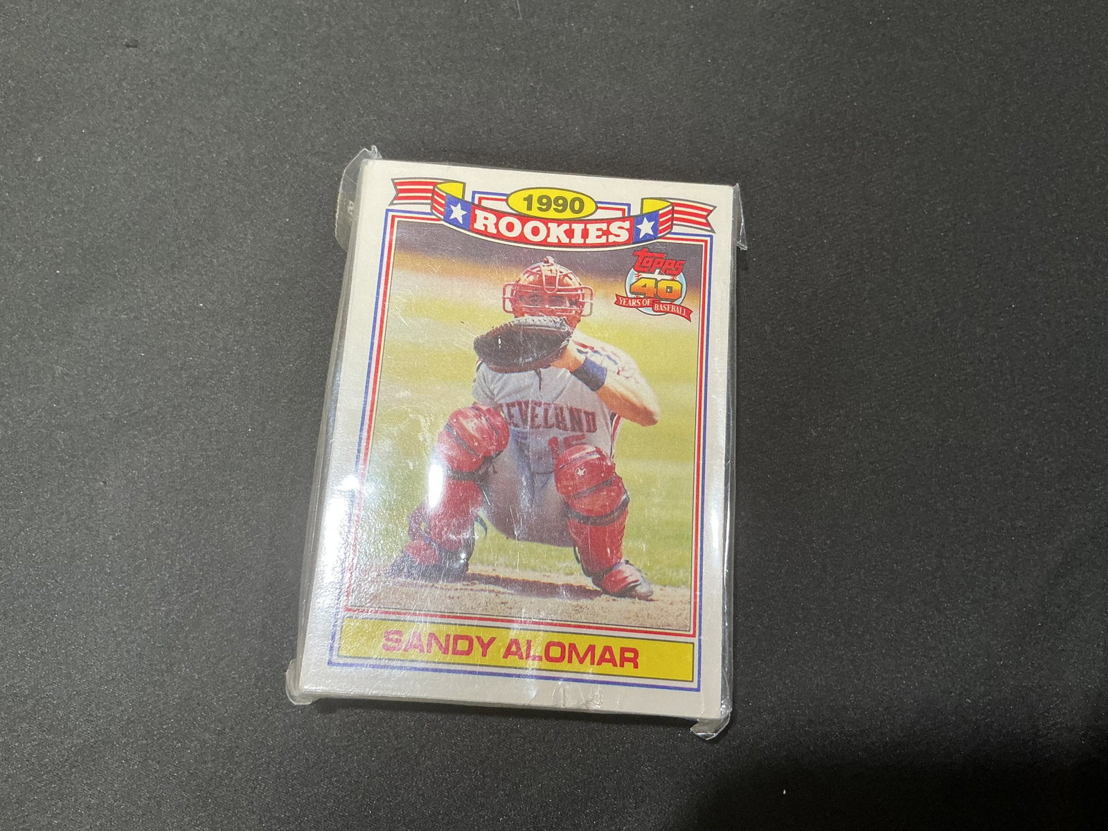 1990 Topps Rookies Commemorative 33-Card Pack: Sealed 1990 Topps Rookies Commemorative 33-card pack featuring notable rookie-era players including Sandy Alomar Jr. and Todd Zeile. Unopened vintage baseball card issue with collector appeal.