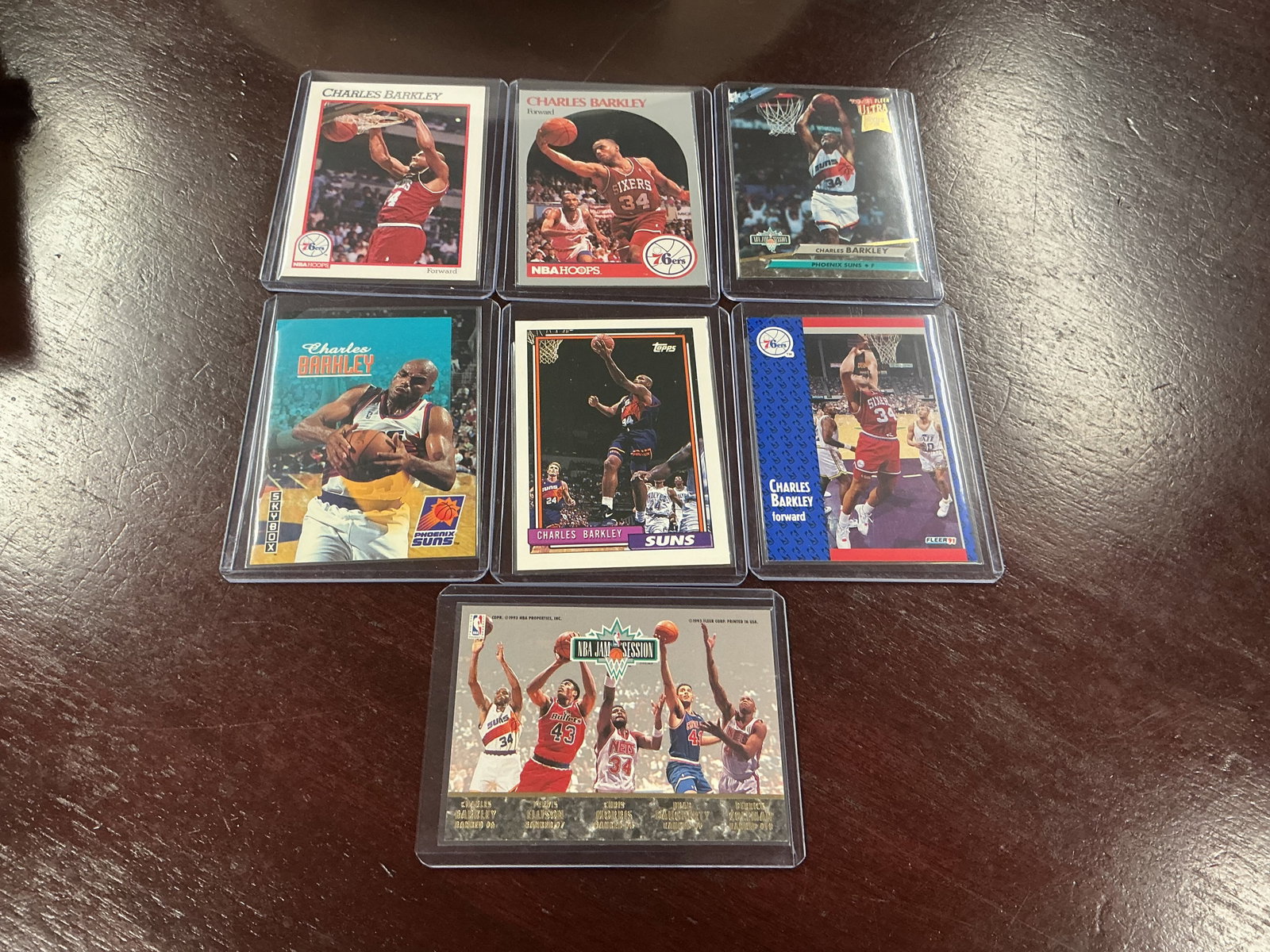 Charles Barkley Basketball Card Lot: Group of seven Charles Barkley basketball cards including Hoops, Fleer, SkyBox, Topps and Ultra issues spanning his 76ers and Suns years. Hall of Fame player lot with strong collector appeal.