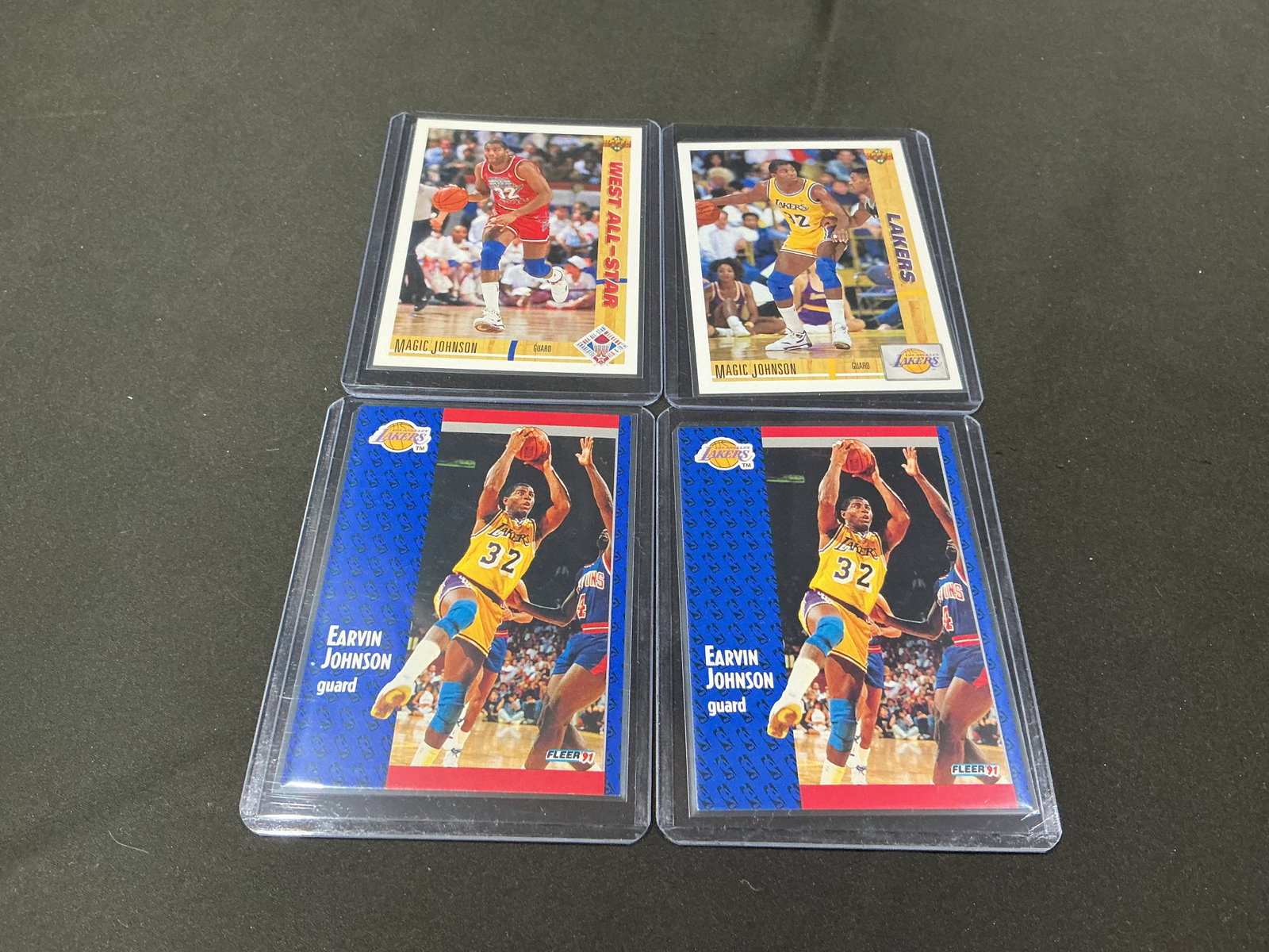 Magic Johnson Basketball Card Lot: Group of four Magic Johnson basketball cards including Los Angeles Lakers and All-Star issues from the early 1990s. Features Hall of Fame point guard Earvin 'Magic' Johnson in a desirable vintage