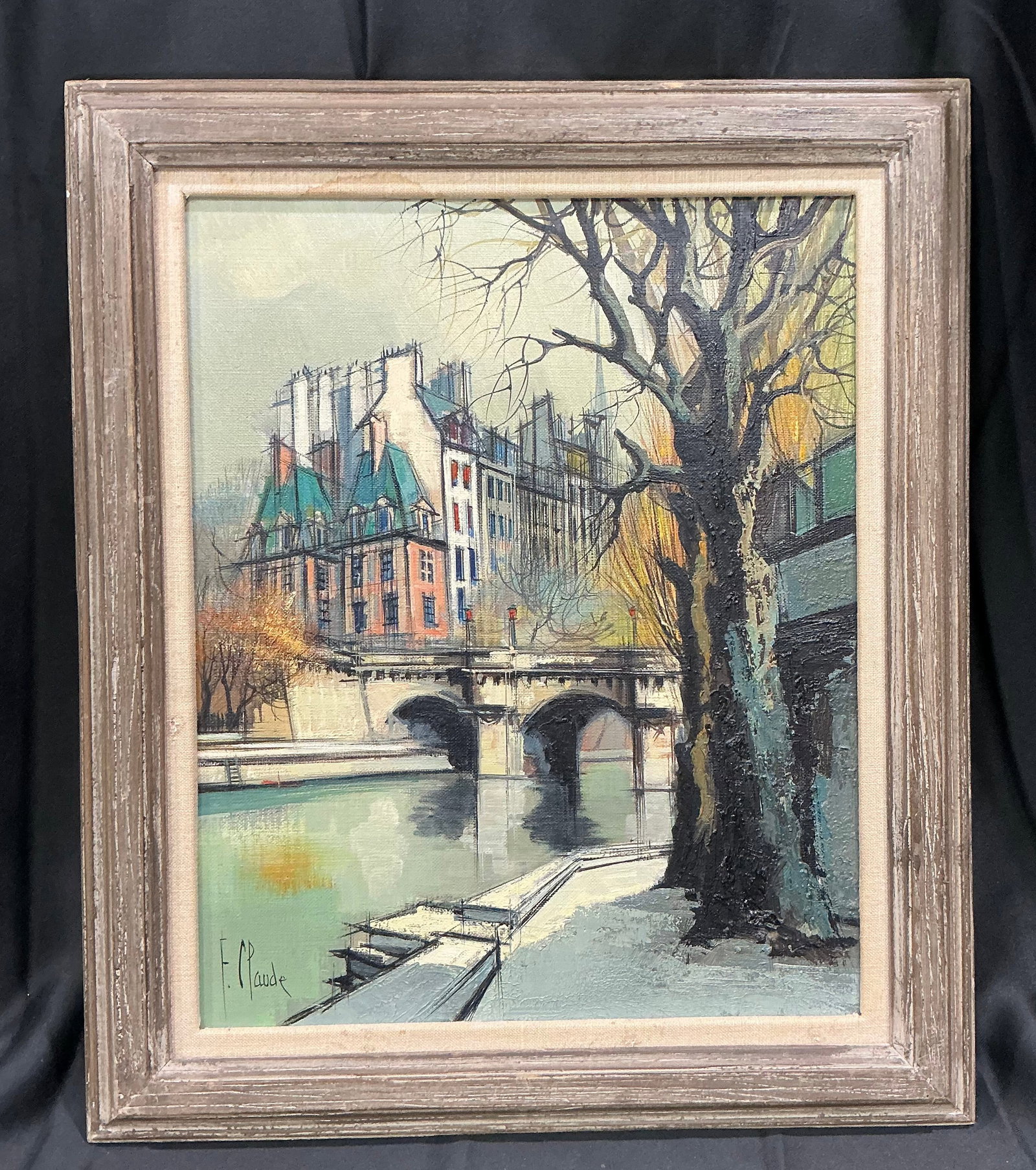 Paris Street Scene Painting Signed E Plaude: Returning offering of a framed Parisian street scene painting signed E Plaude. Features a bridge over a river, classic European architecture, and atmospheric cityscape details rendered in a soft