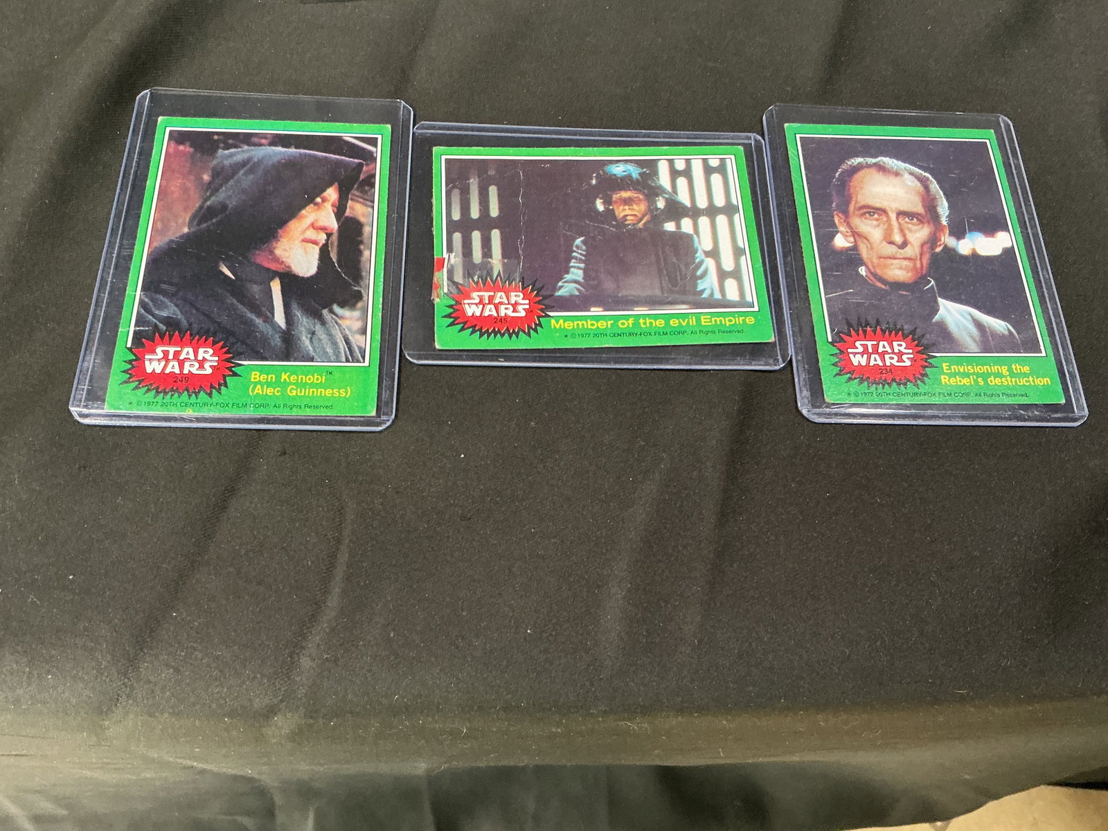 Star Wars Green Series Card Trio: Three-card Star Wars lot featuring Ben Kenobi (Alec Guinness), Imperial officer imagery, and Grand Moff Tarkin character cards. Classic Star Wars collector grouping with strong appeal for vintage-styl
