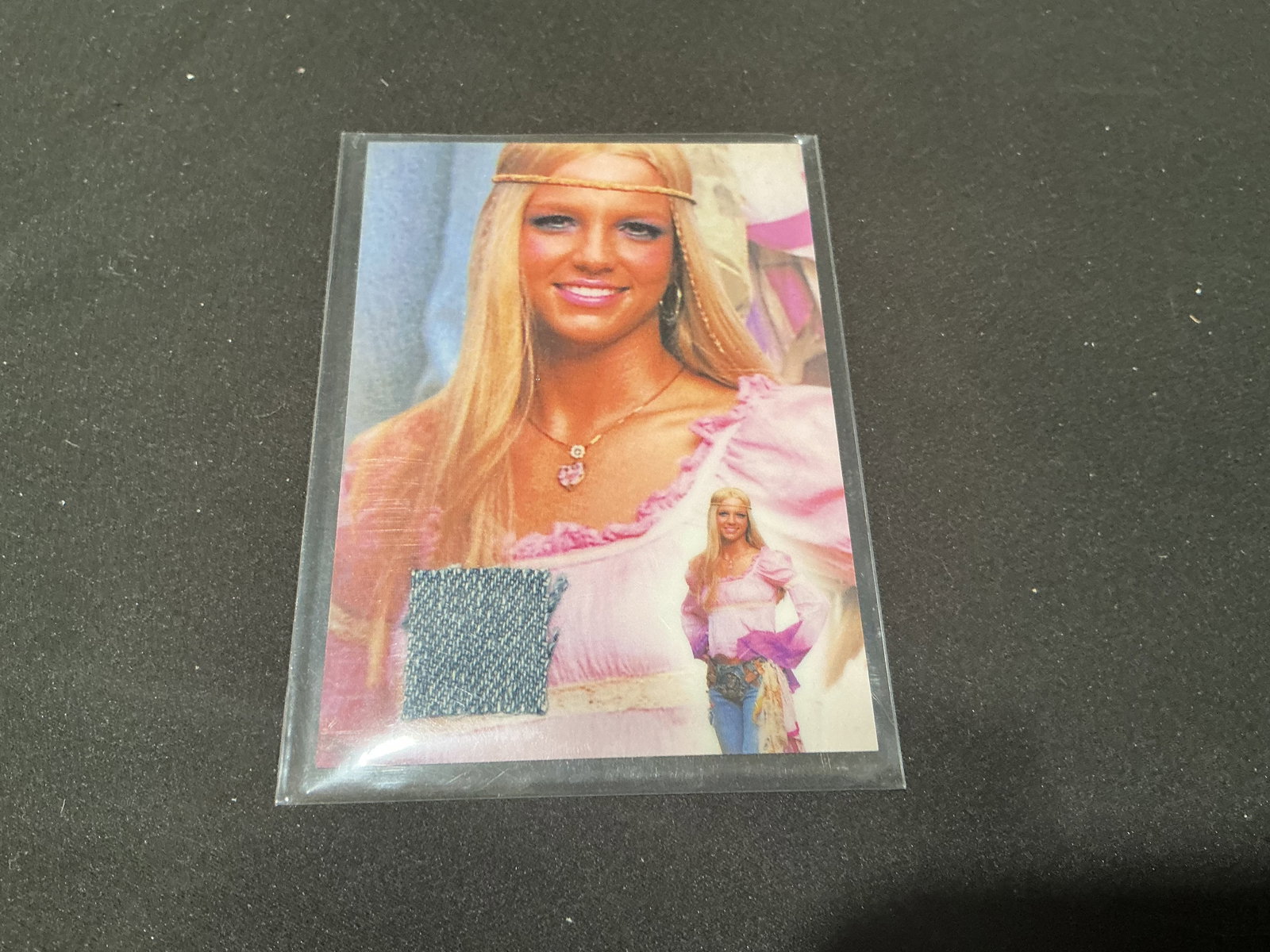 Britney Spears Certified Relic Card: Certified Britney Spears memorabilia relic card featuring embedded costume or wardrobe swatch with printed certificate of authenticity on reverse. Entertainment collectible with strong appeal for pop 