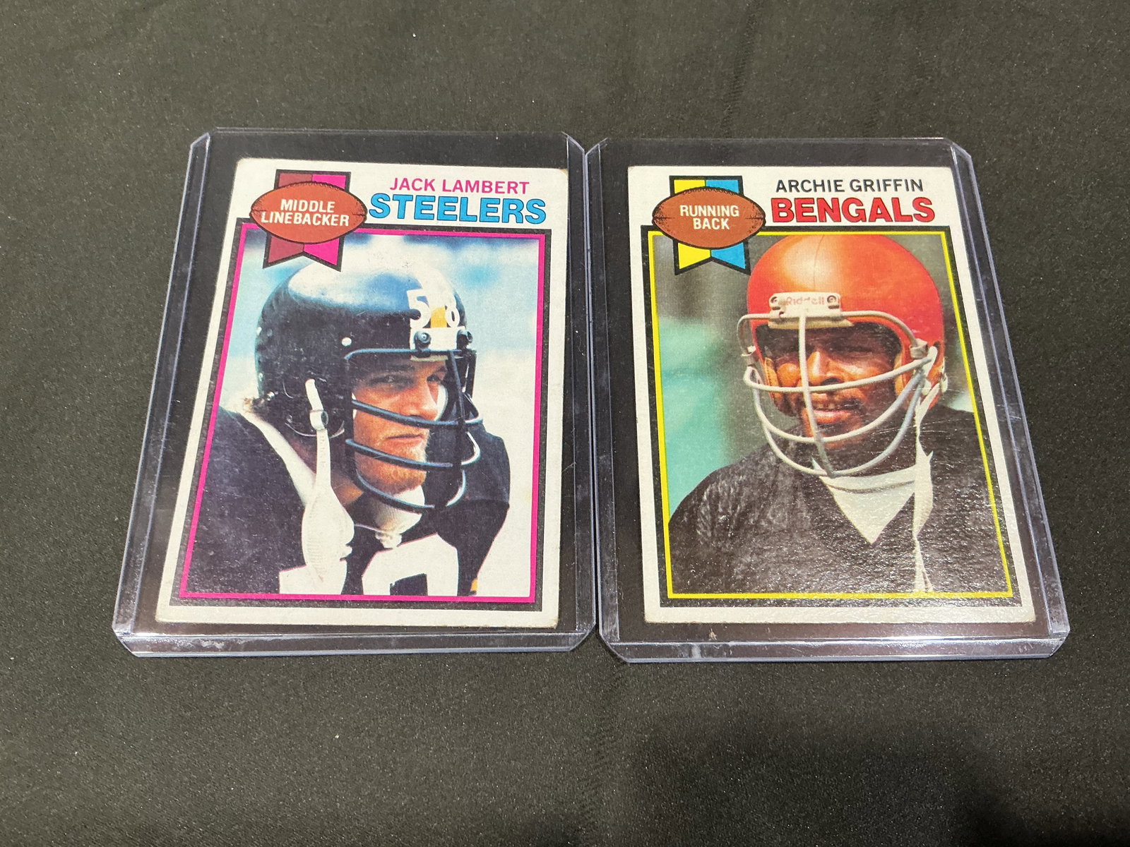Jack Lambert & Archie Griffin Card Pair: Vintage football card pair featuring Hall of Fame linebacker Jack Lambert of the Pittsburgh Steelers and two-time Heisman Trophy winner Archie Griffin of the Cincinnati Bengals. Classic late-1970s