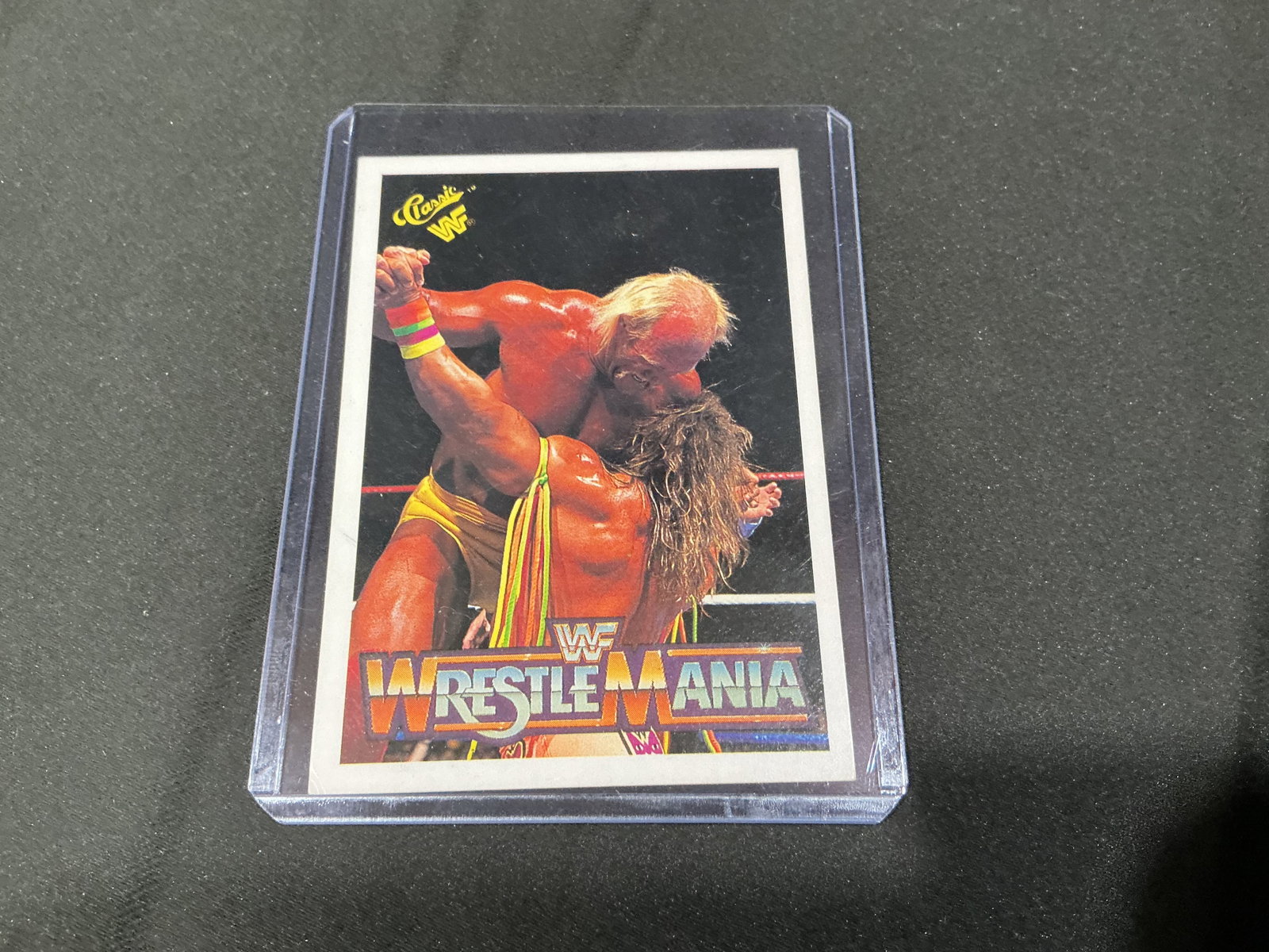 1990 WWF WrestleMania VI Hogan Warrior Card: 1990 Classic WWF WrestleMania VI trading card featuring Hulk Hogan and Ultimate Warrior from their iconic WrestleMania VI matchup. Strong wrestling collector appeal with two major WWF stars on one car