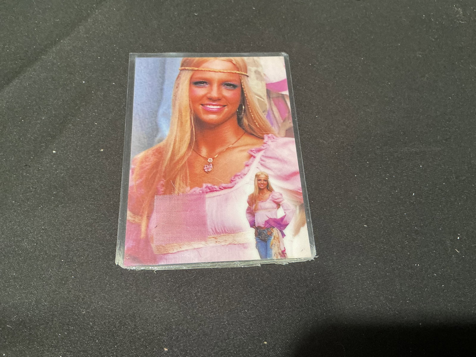 Britney Spears Authentic Relic Card: Certified Britney Spears memorabilia relic card featuring embedded costume or fabric swatch with certificate of authenticity on reverse. Pop culture collectible with strong appeal to music and
