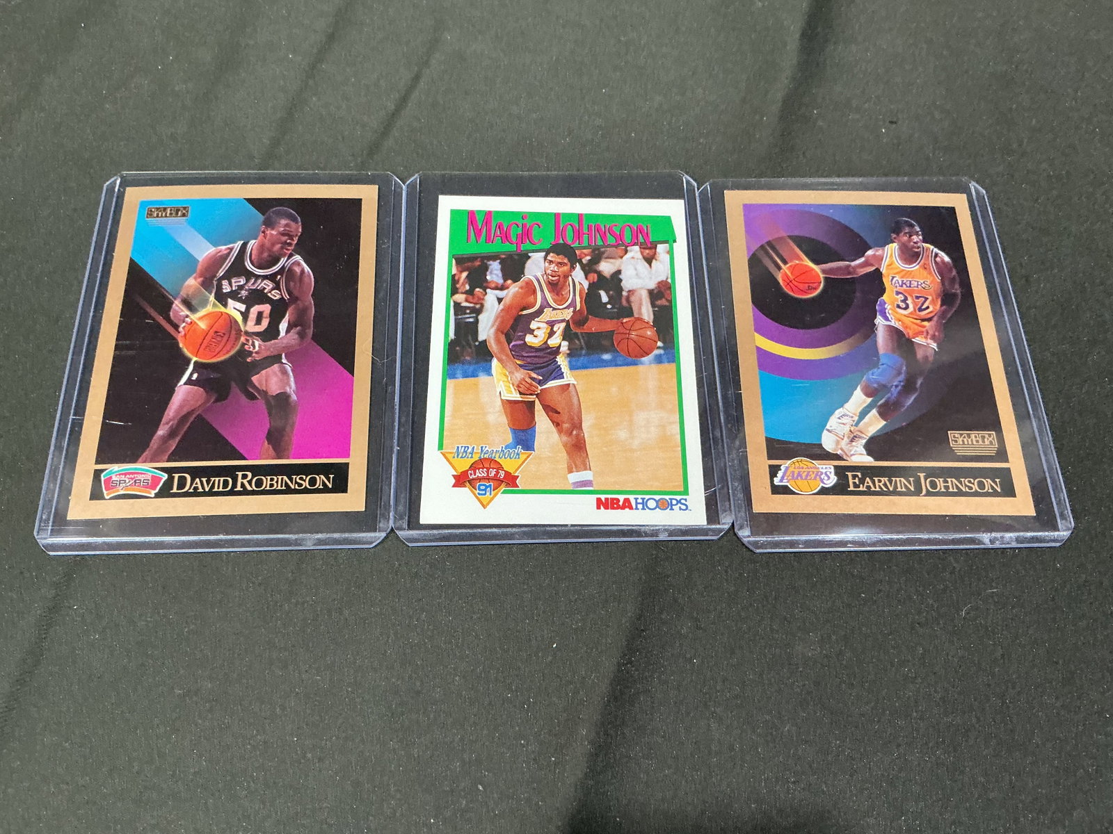 Magic Johnson & David Robinson Cards: Three-card basketball lot featuring Magic Johnson and David Robinson cards including NBA Hoops and SkyBox examples. Estimated shipping $10-$16.