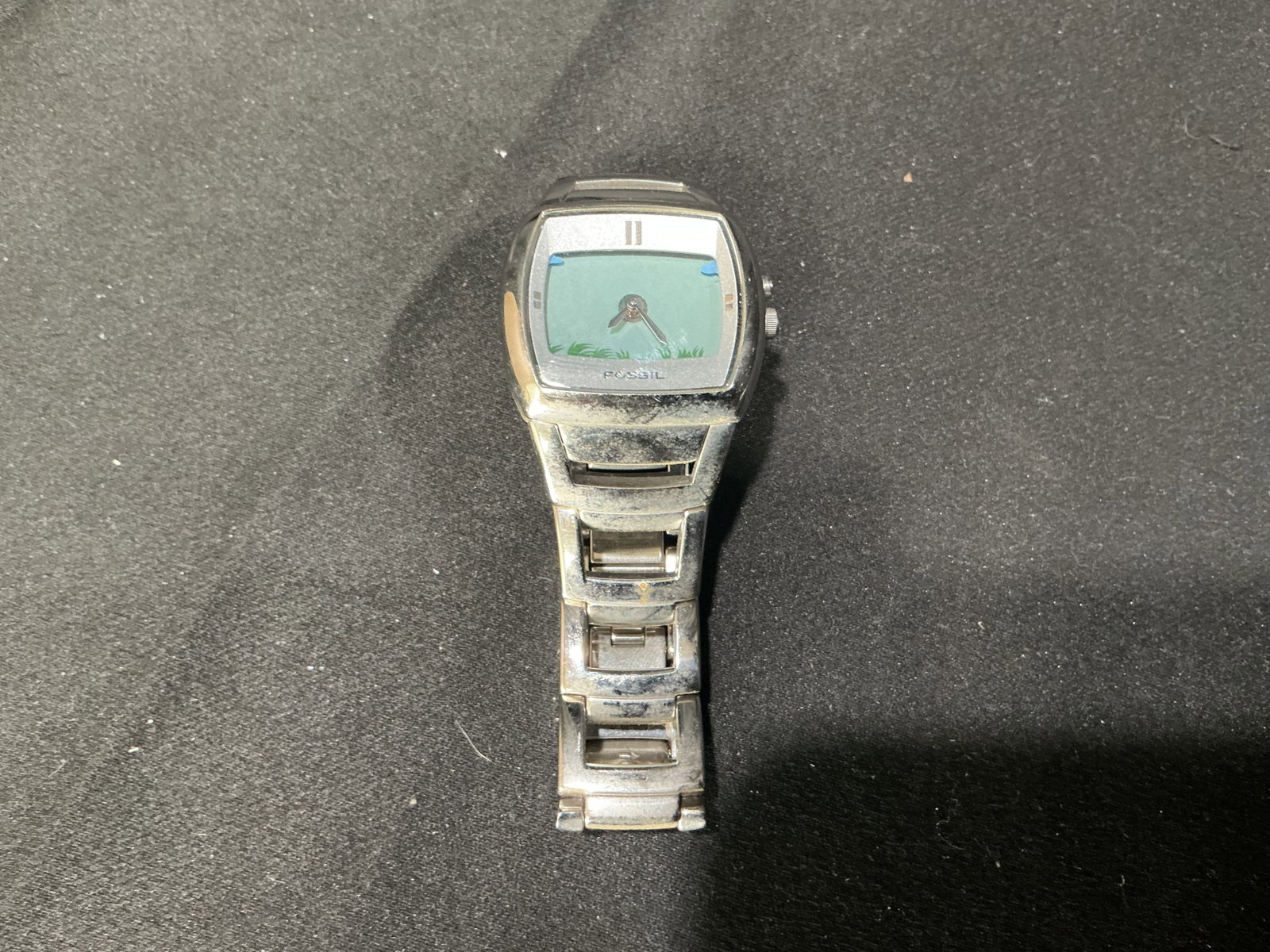 Fossil Stainless Steel Wristwatch: Fossil stainless steel quartz wristwatch featuring a modern rectangular case, matching link bracelet, and distinctive blue gradient dial. A stylish everyday wristwatch with contemporary design