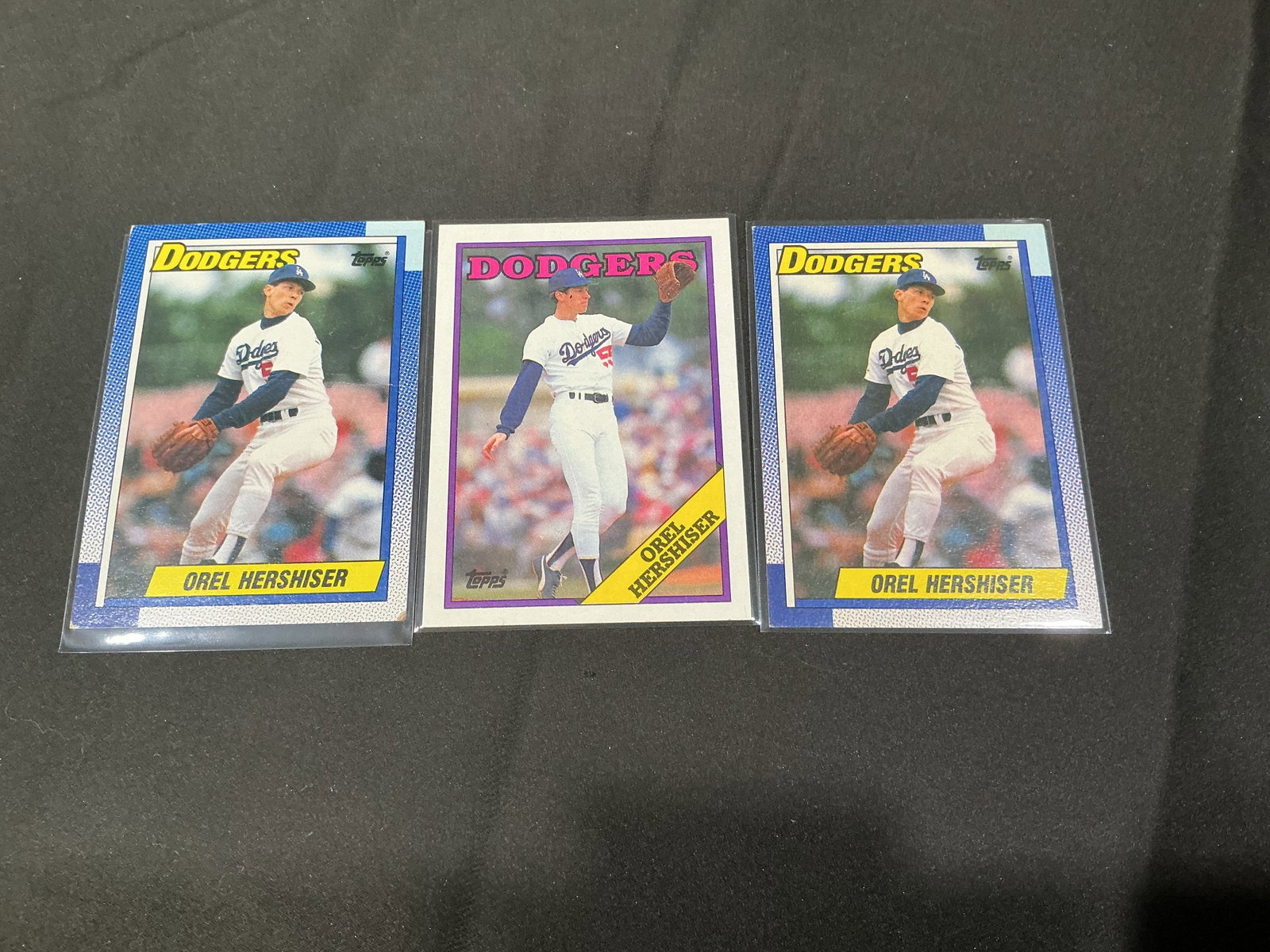 Orel Hershiser Baseball Card Trio: Back again, this lot features three Orel Hershiser baseball cards including two 1990 Topps #780 examples and one 1989 Topps card. Vintage Dodgers star card groupings like this have sold in our