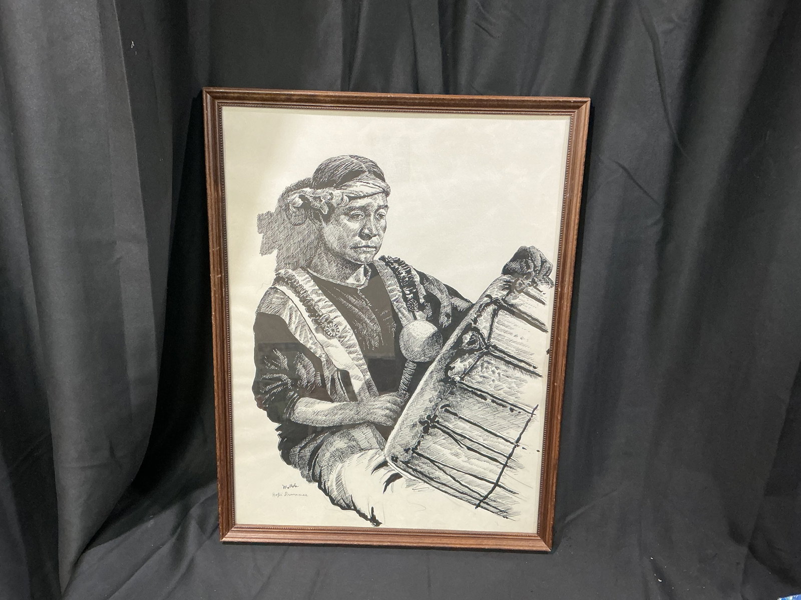 Motola 'Hopi Drummer' Framed: Signed Motola artwork titled 'Hopi Drummer' depicting a Native American drummer in detailed monochrome style. Framed under glass and ready for display, offering Southwestern and Native American art