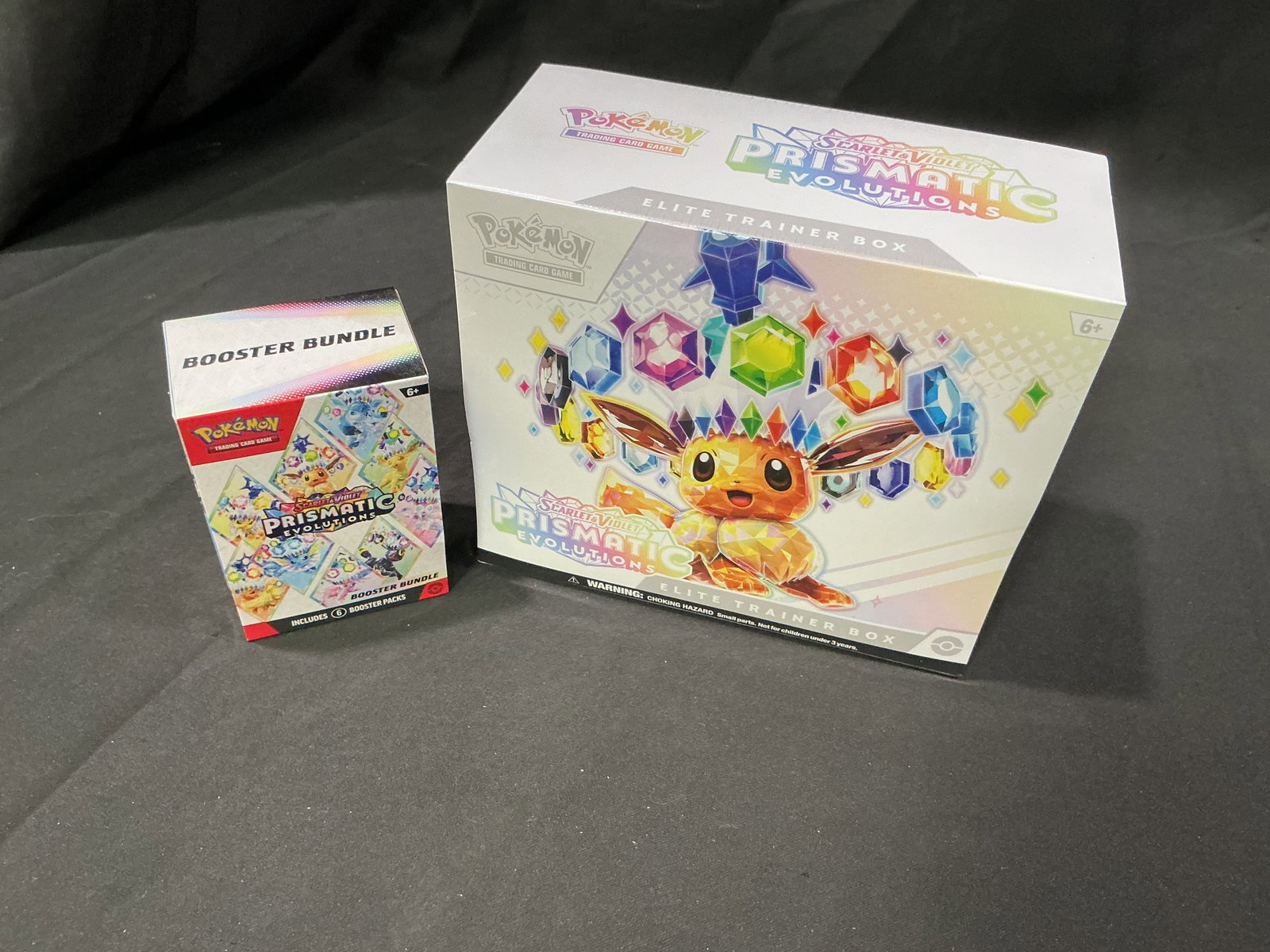 Prismatic Evolutions ETB & Booster Bundle: Another opportunity to acquire this sealed pairing combining a Prismatic Evolutions Elite Trainer Box with a matching Prismatic Evolutions Booster Bundle. Together these popular products offer a