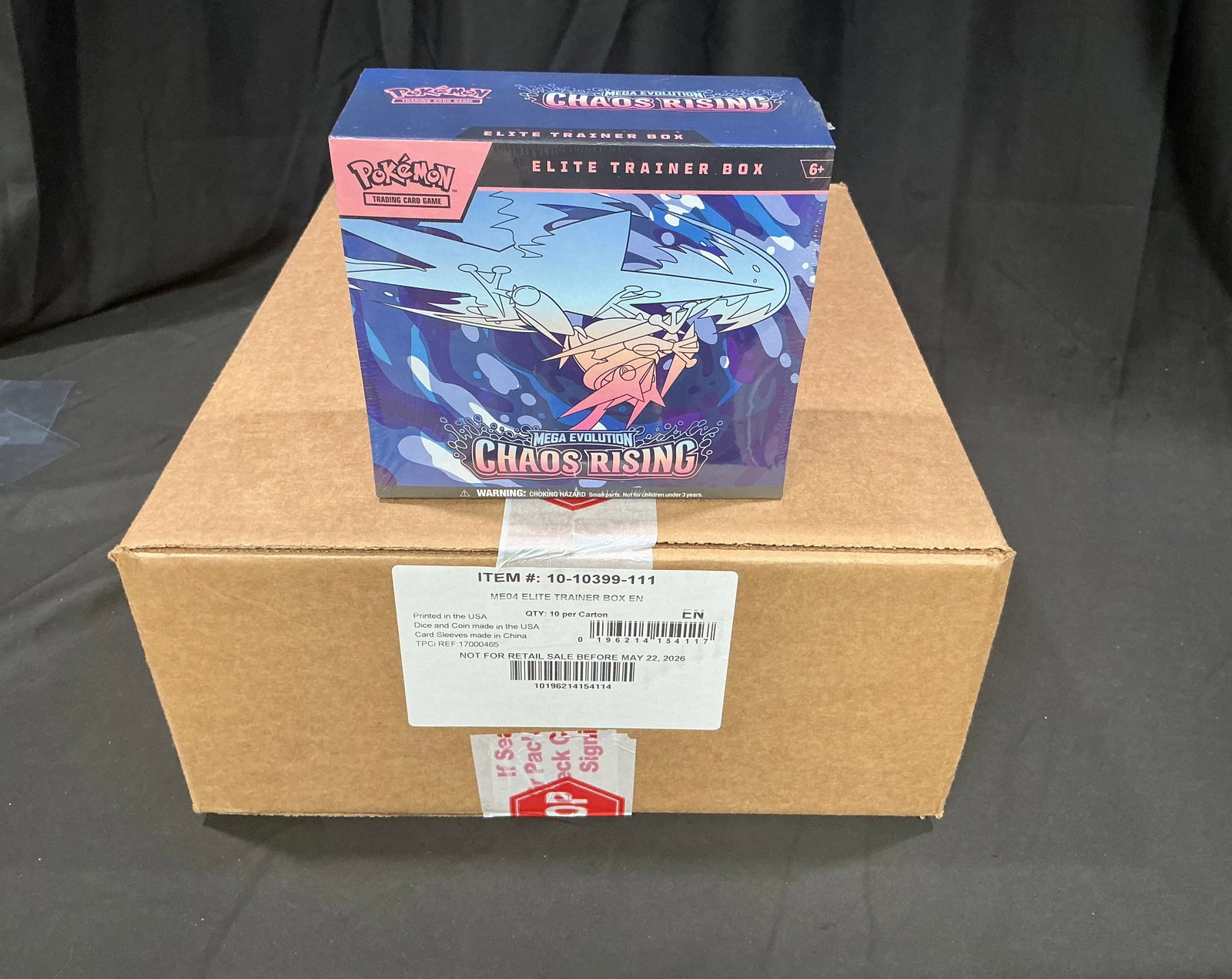 Factory Sealed Chaos Rising ETB Case: Featured again after a strong showing last time, this factory sealed master case contains 10 Pokemon Mega Evolution Chaos Rising Elite Trainer Boxes, with one ETB shown for reference only and not incl
