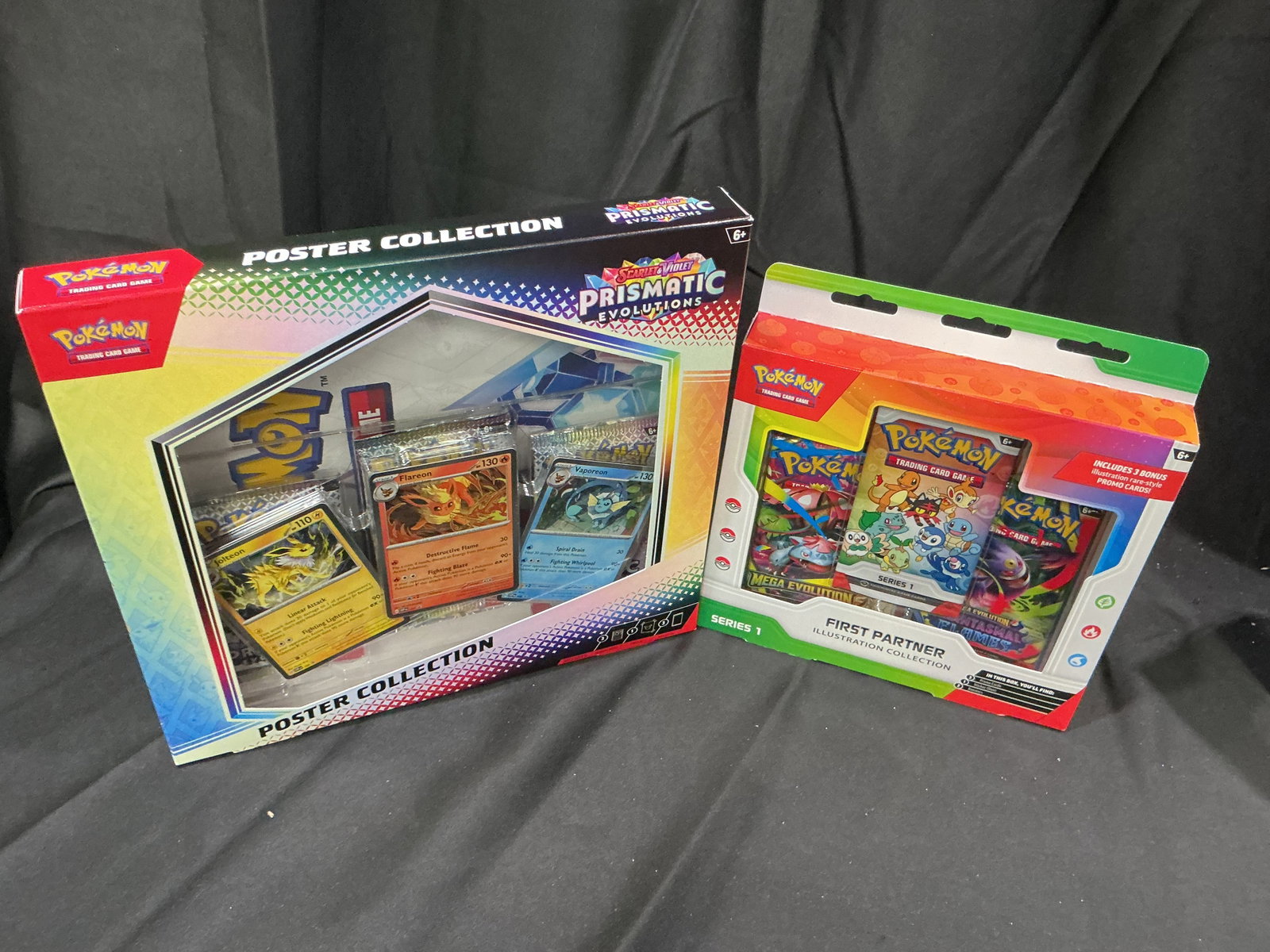 Prismatic Poster & First Partner: Offered once more, this exact combination has appeared in our auctions. Factory sealed Pokemon Prismatic Evolutions Poster Collection paired with a Series 1 First Partner Illustration Collection,