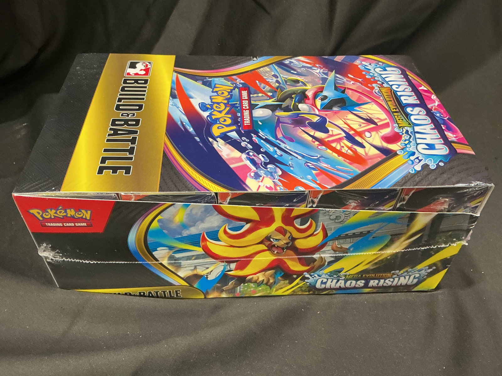 Chaos Rising Build & Battle Display: Returning after a prior appearance, this factory sealed Pokemon Mega Evolution Chaos Rising Build & Battle display box contains 10 sealed Build & Battle kits from the Mega Evolution release. A