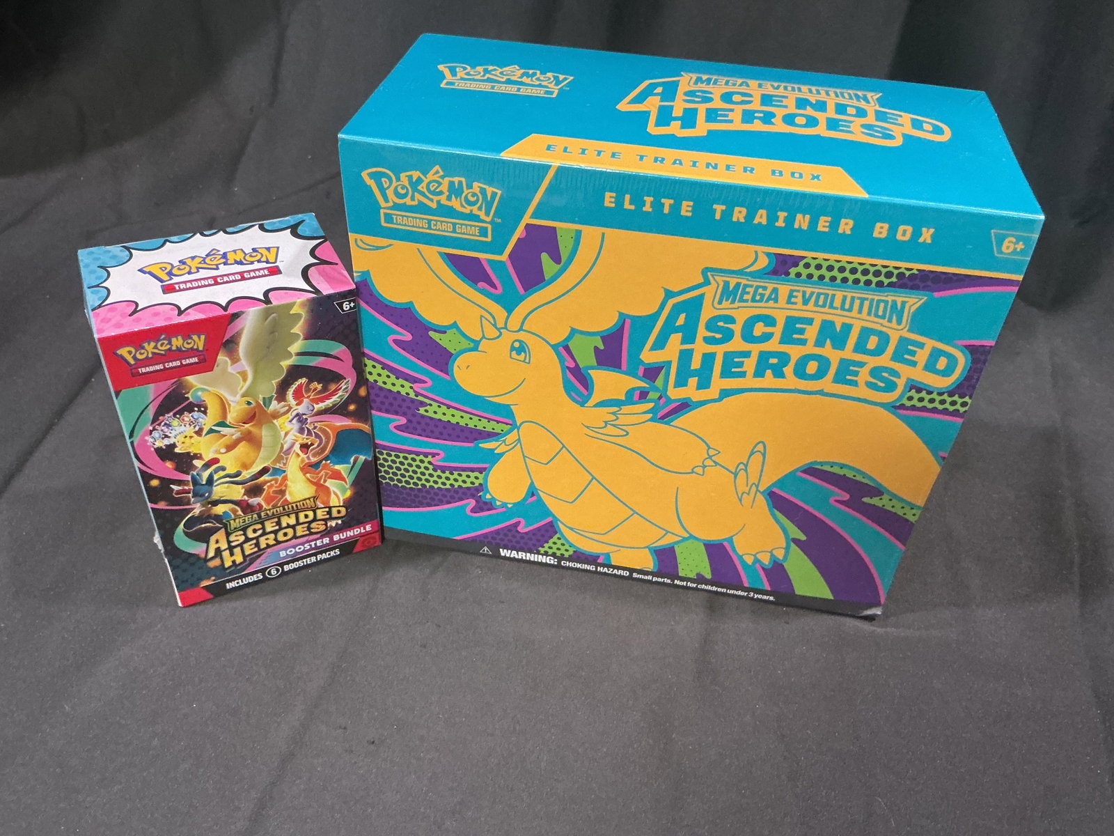 Ascended Heroes ETB & Bundle Set: Dragonite-themed artwork ties together this factory sealed Pokemon Mega Evolution Ascended Heroes Elite Trainer Box and matching Ascended Heroes Booster Bundle. A combination that has consistently per