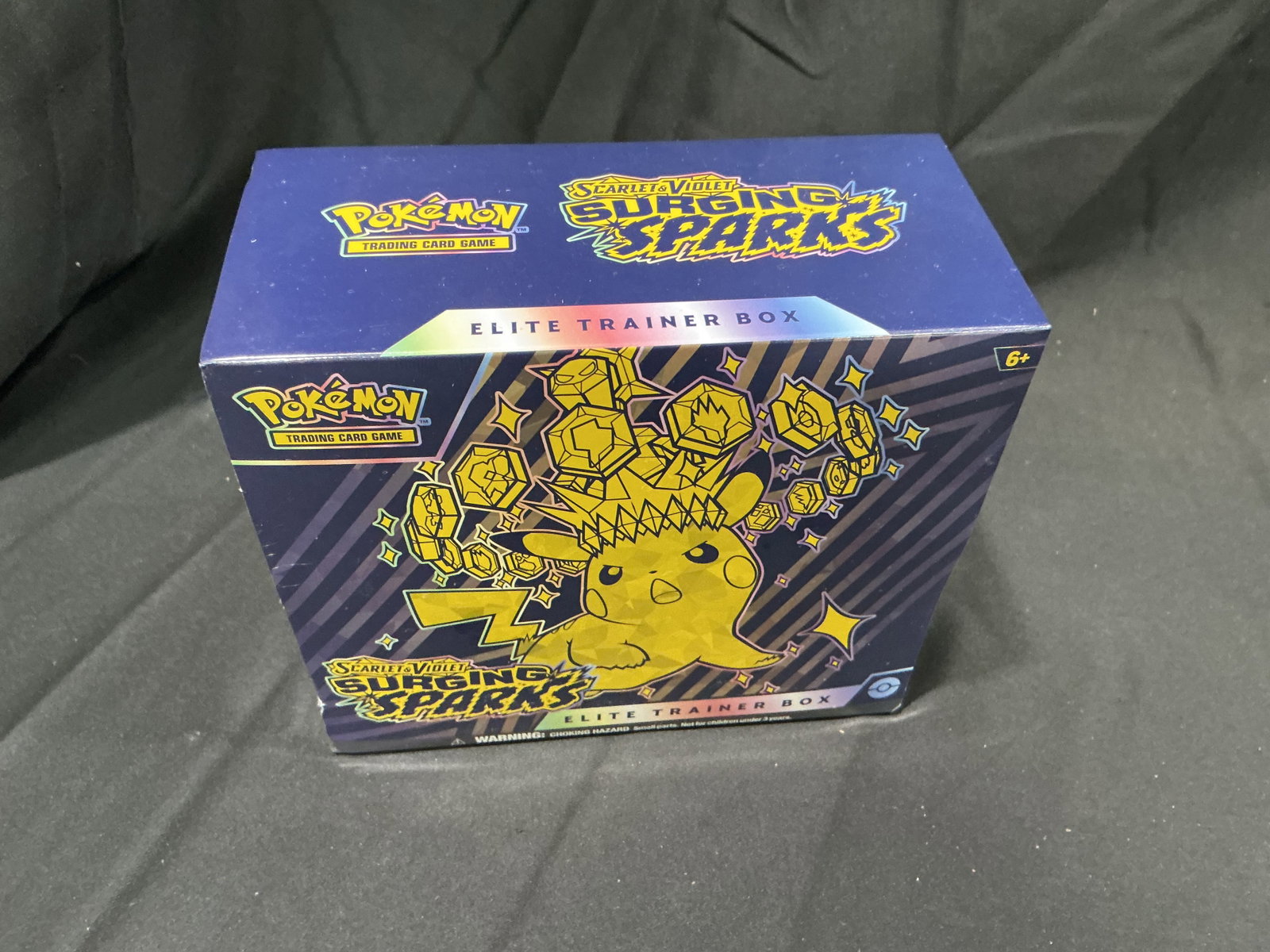 Pokemon Surging Sparks ETB: Back after a short absence from our auctions, this factory sealed Pokemon Scarlet & Violet Surging Sparks Elite Trainer Box has previously sold and returns for another opportunity. With only a single 