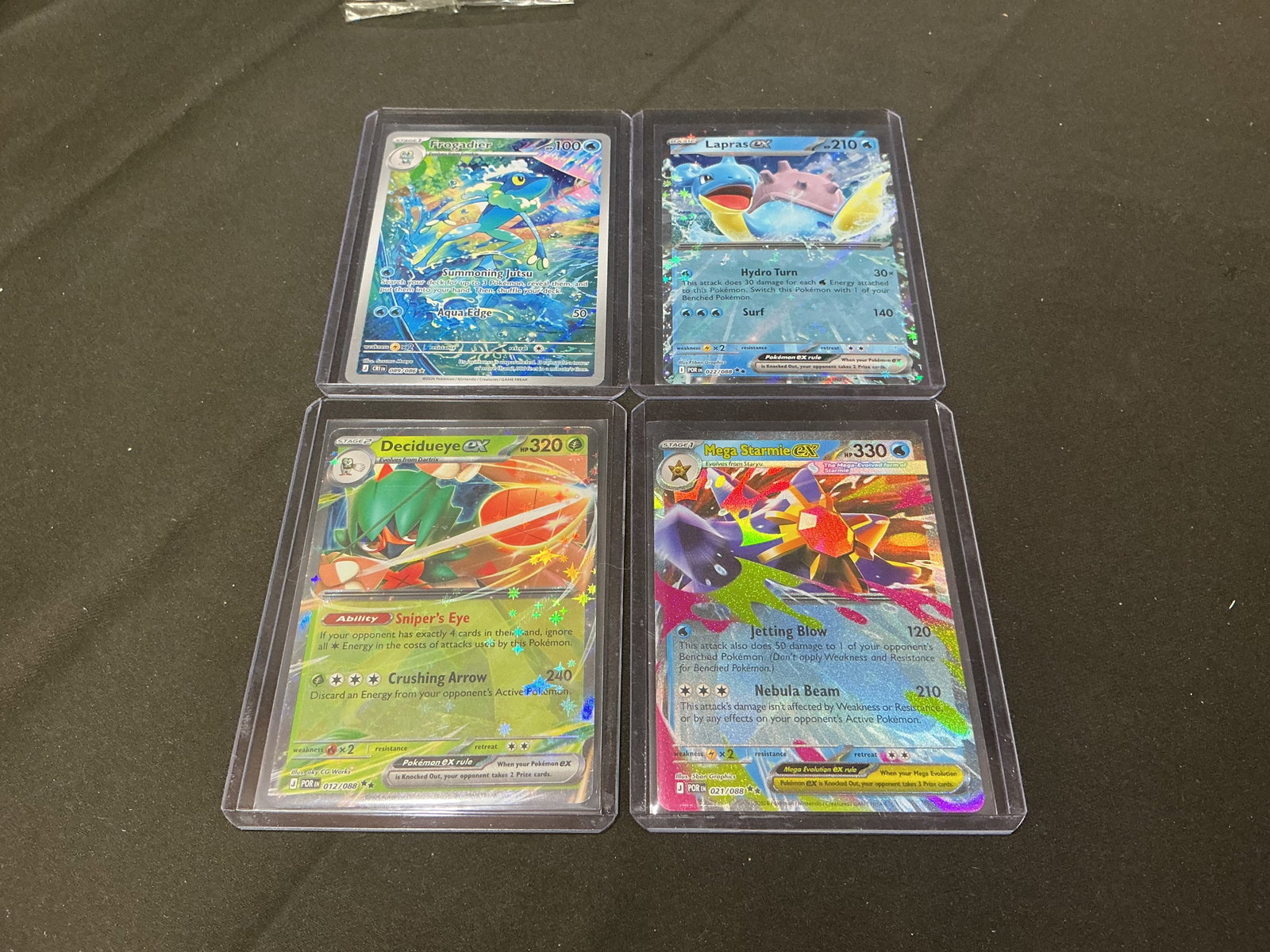 Pokemon Full Art Card Lot: Featured again, this lot includes four modern Pokemon cards featuring Frogadier, Lapras ex, Decidueye ex, and Mega Starmie ex. A colorful assortment of full art and ex cards that continues to attract
