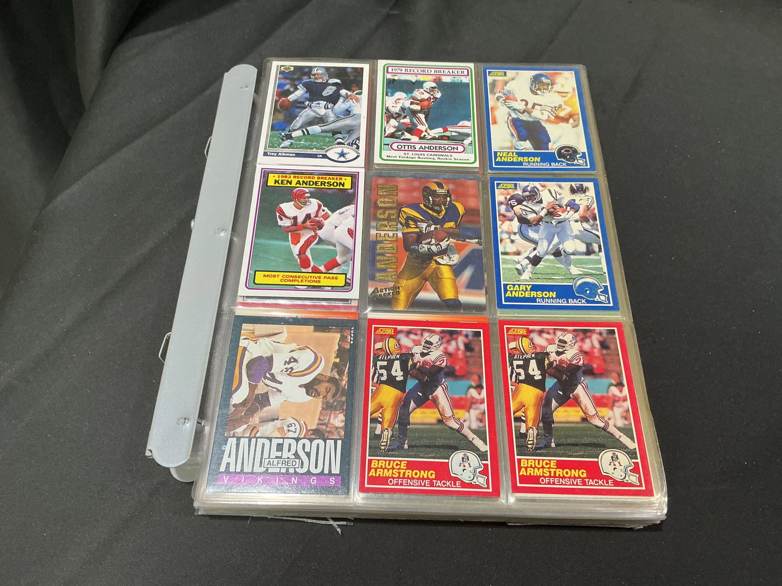 Football Card Binder w/ Aikman & Allen: Large binder containing vintage football trading cards from multiple manufacturers and eras. Includes cards featuring Troy Aikman, Marcus Allen, Steve Young, Bernie Kosar, Keith Byars, Otis Anderson,