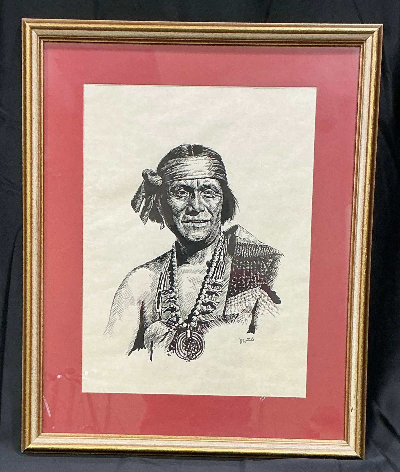 Motola Native American Portrait: Framed pen-and-ink portrait signed Motola, depicting a Native American figure in traditional attire with finely rendered facial detail, beadwork, and garment textures. Marked 30/290 and #31 on the