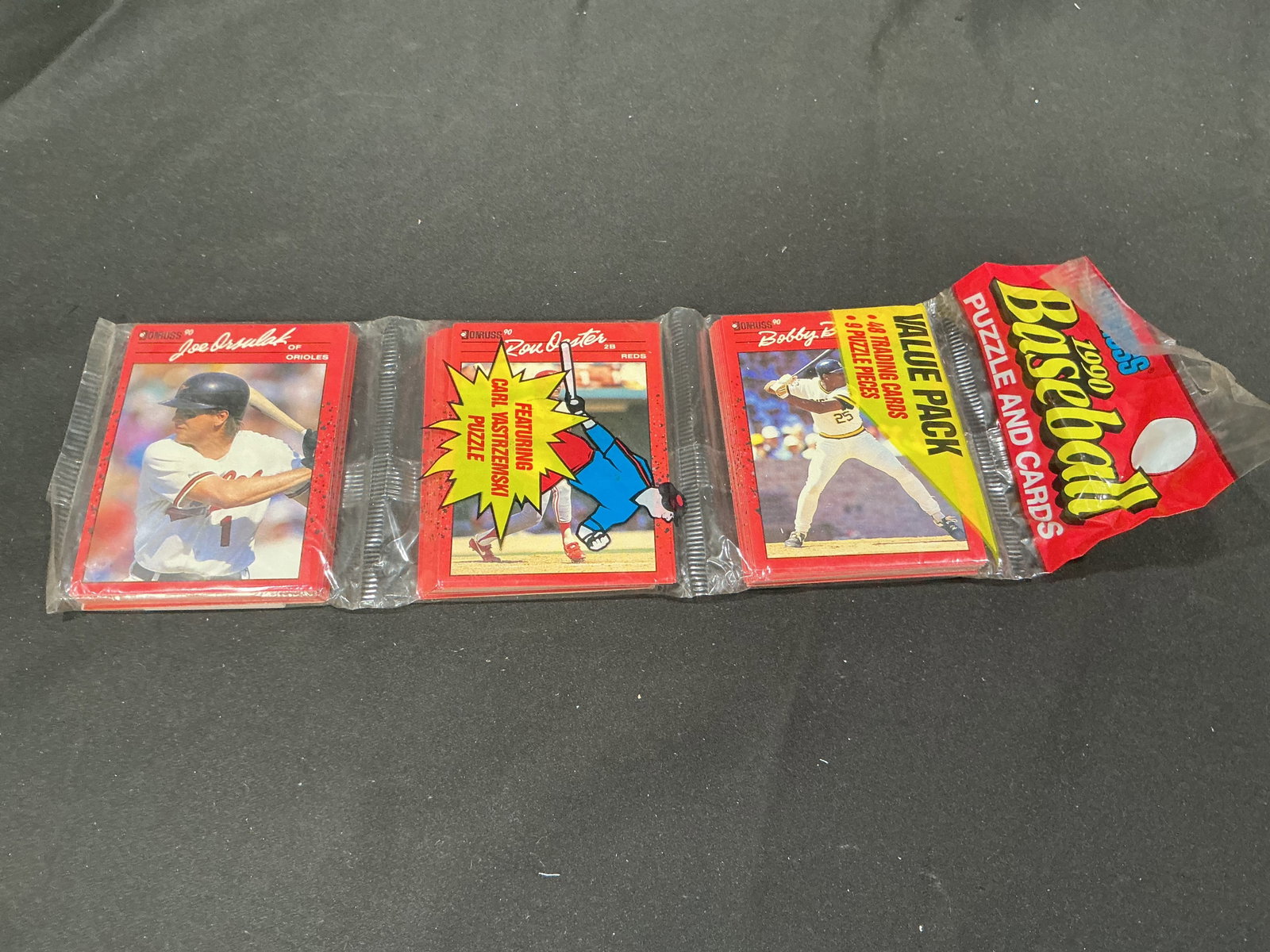 1990 Donruss Baseball Value Pack: Returning to our auctions, sealed 1990 Donruss Baseball Value Pack containing 48 trading cards and a 9-piece puzzle in the original factory wrapper. An affordable unopened vintage pack offering