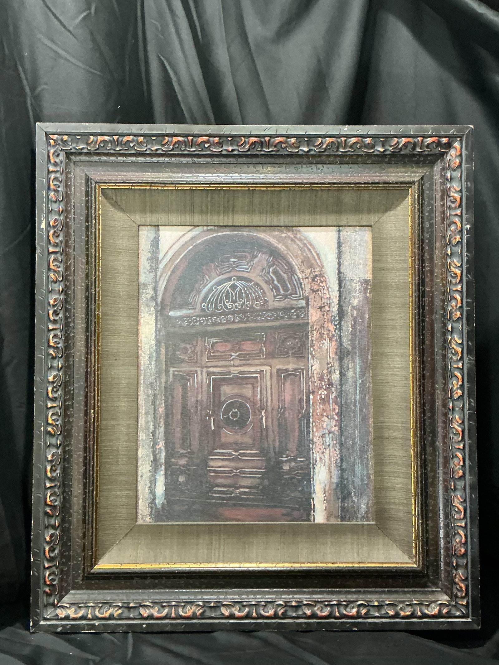 Signed Architectural Doorway Painting: Signed framed architectural artwork depicting an ornate historic doorway in warm, muted tones with textured surface details. Presented beneath a fabric-lined mat in a decorative carved-style frame.