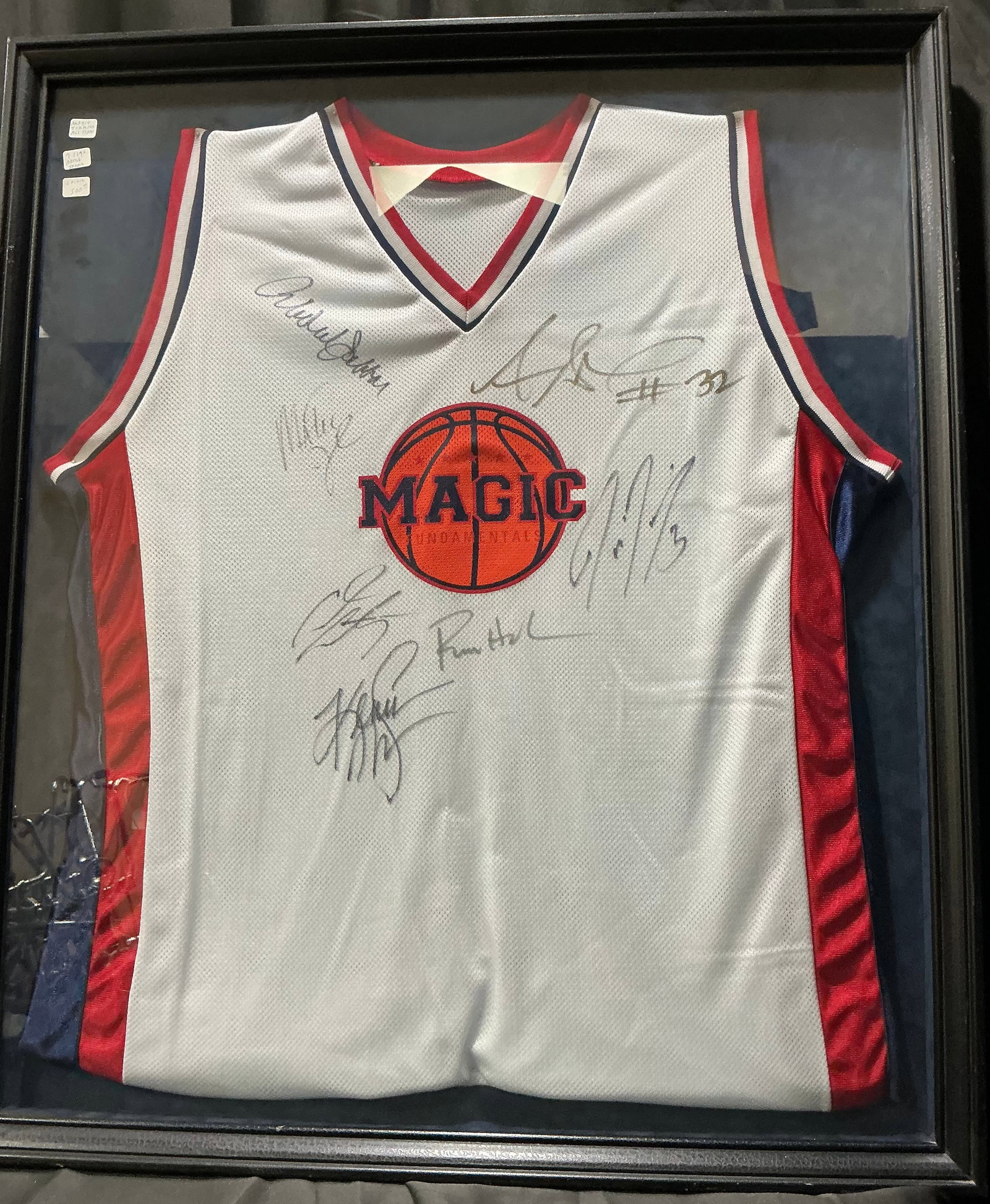 Signed Magic Fundamentals Jersey Display: Framed Magic Fundamentals basketball jersey display featuring multiple player autographs, including Magic Johnson, with accompanying Magic Fundamentals promotional documentation. An attractive