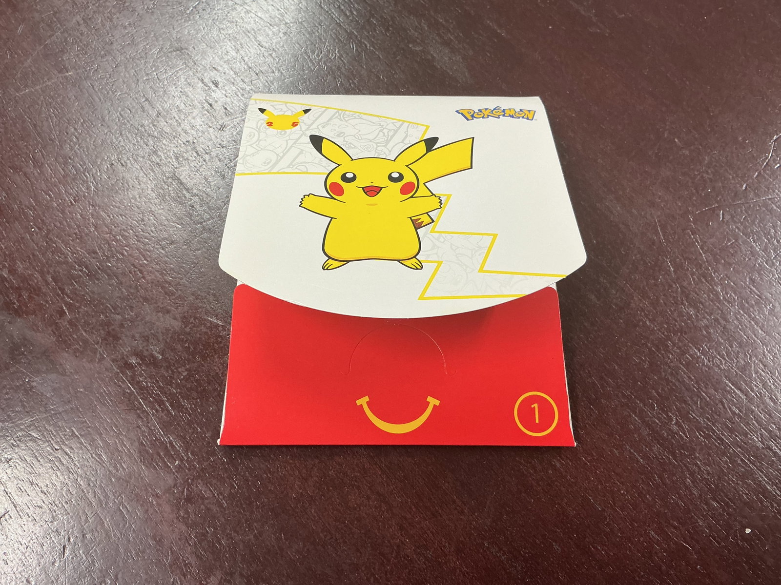 White Pokemon Pikachu Happy Meal Card Pack: Back for another opportunity, this Pokemon McDonald's 25th Anniversary Happy Meal box includes a sealed four-card Pokemon Trading Card Game pack with Pikachu-themed packaging and activity insert. A