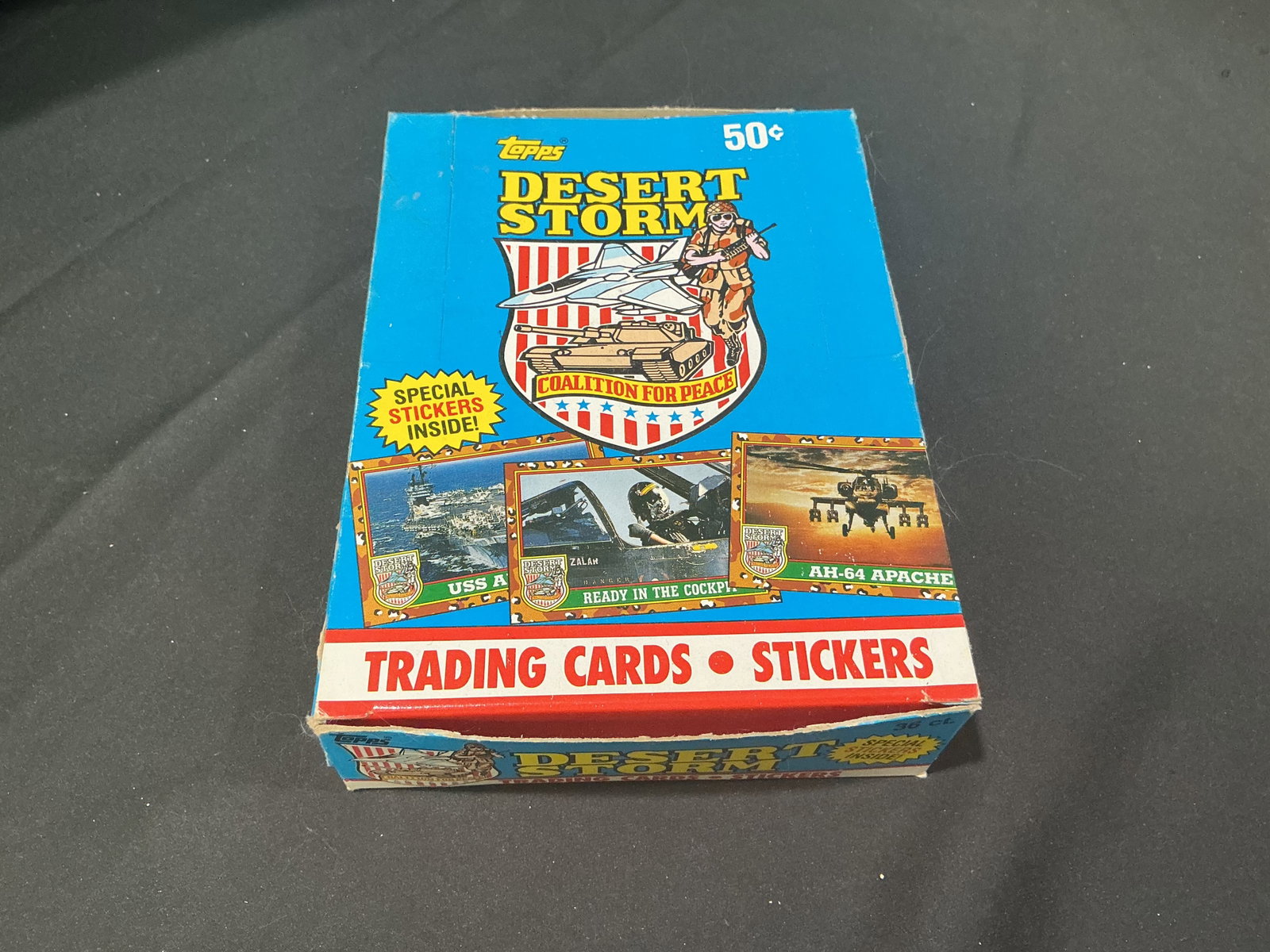 Topps Desert Storm Card Box: Featured once again, this vintage Topps Desert Storm trading card display box showcases the Coalition for Peace release from the early 1990s. Includes trading cards and special stickers housed in the