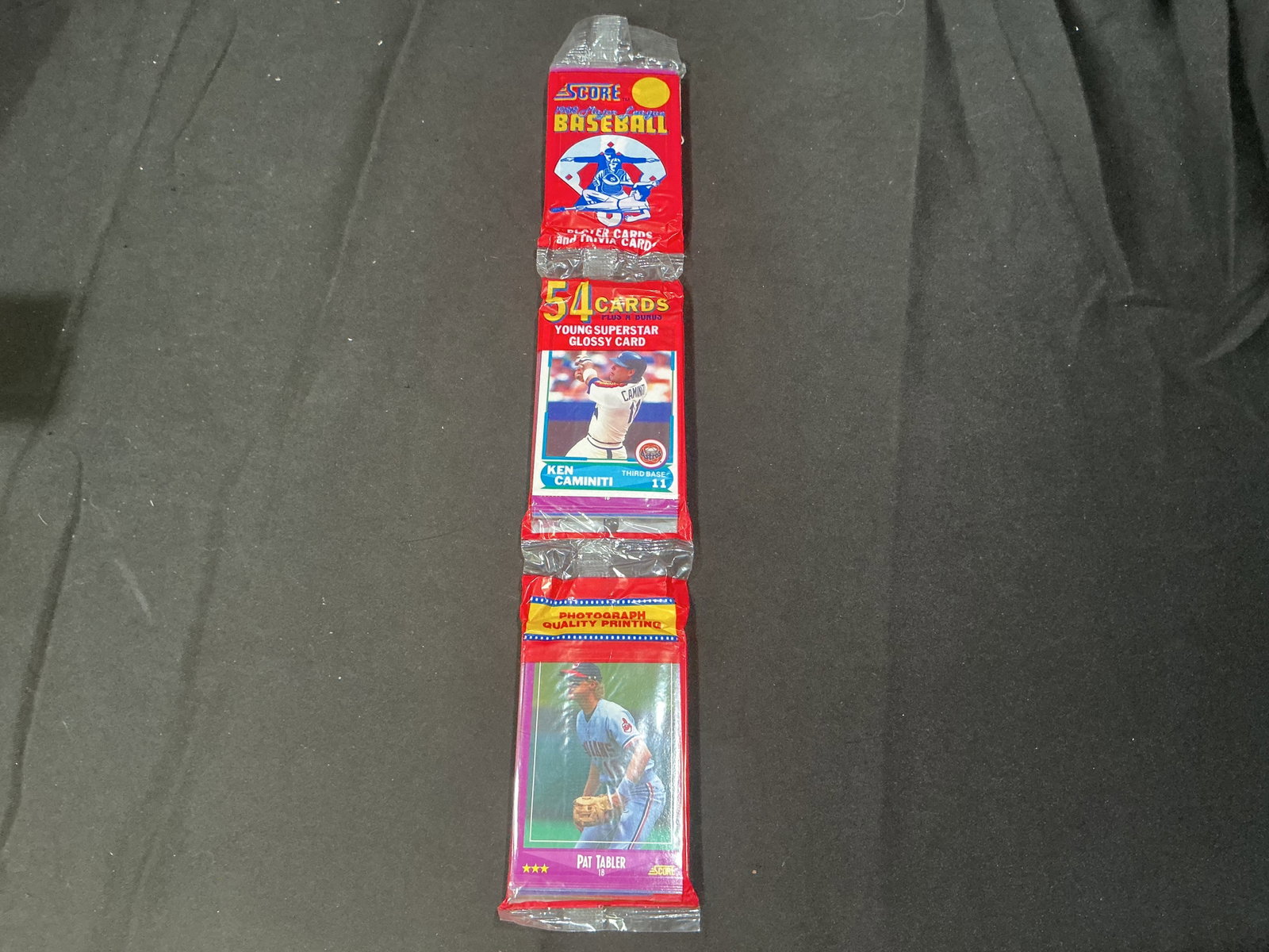 1988 Score Baseball Rack Pack: Back again, this factory sealed 1988 Score Baseball rack pack contains 54 player and trivia cards plus one Young Superstar glossy card. Example players visible include Ken Caminiti and Pat Tabler. An