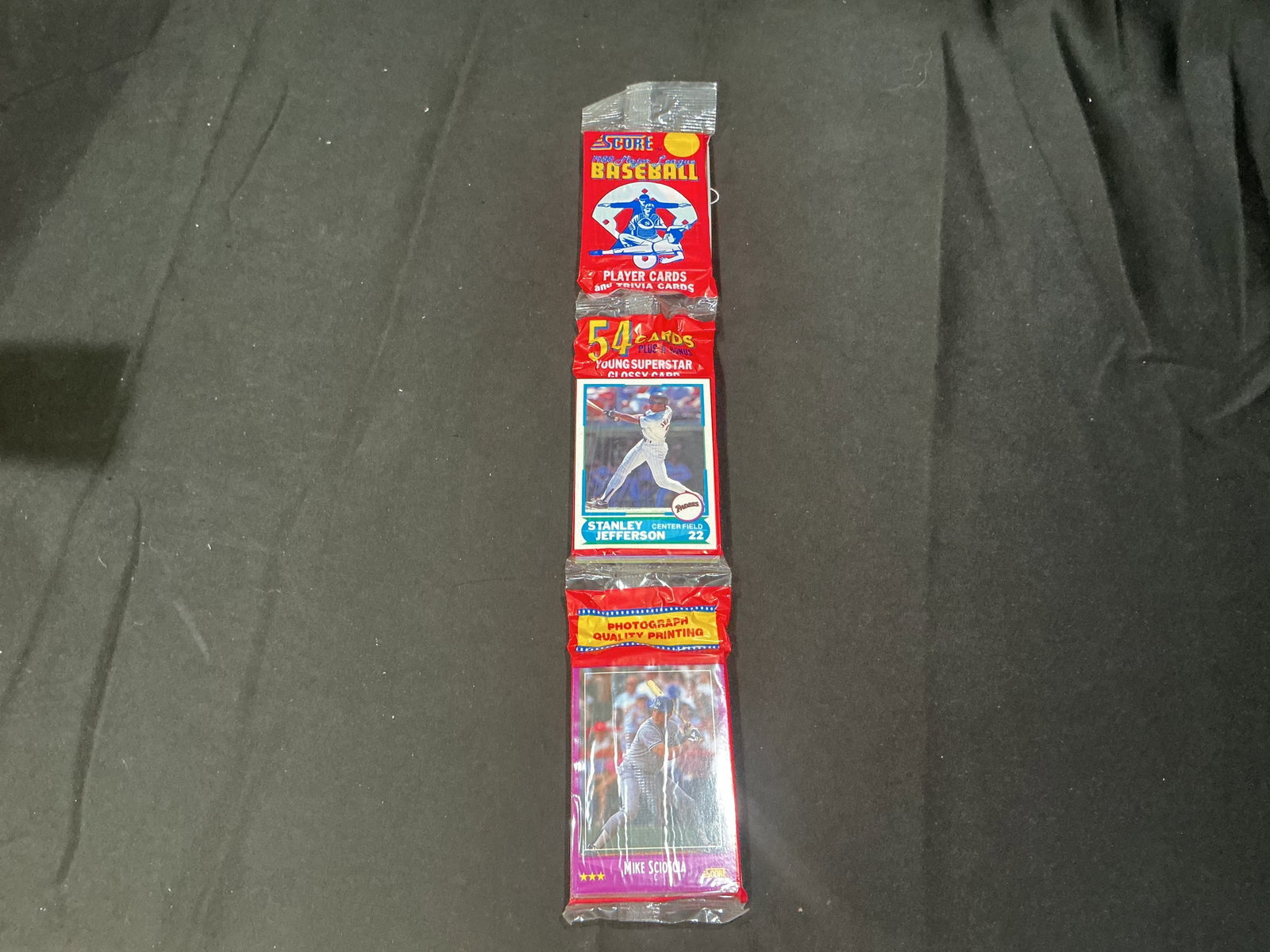 1988 Score Baseball Rack Pack: Factory sealed 1988 Score Baseball rack pack containing 54 player and trivia cards plus one Young Superstar glossy card. Example players visible include Stanley Jefferson and Mike Scioscia. An afforda