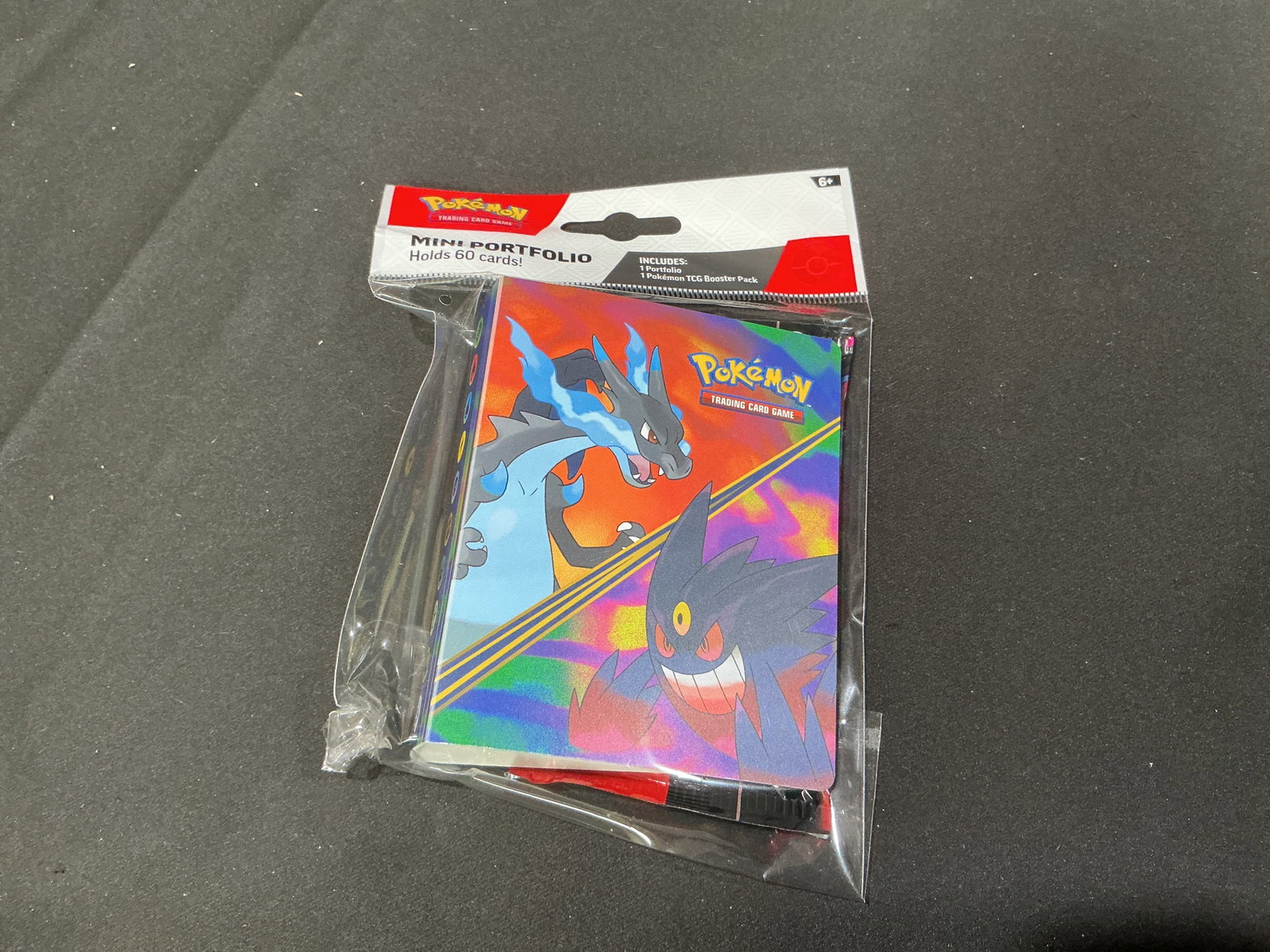 Phantasmal Flames Pack & Mini Portfolio: Factory sealed Pokemon Trading Card Game Mini Portfolio packaged with one Mega Evolution Phantasmal Flames booster pack. The mini portfolio holds up to 60 cards and features Charizard and Gengar