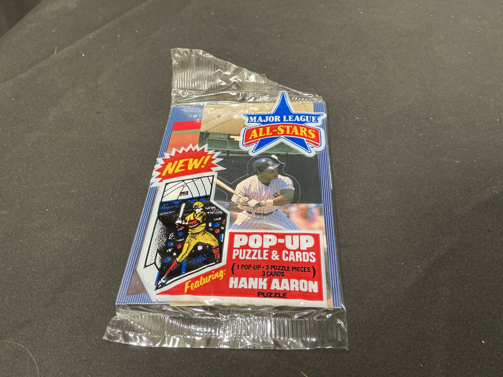 1985 Major League All-Stars Pack: Factory sealed 1985 Major League All-Stars baseball pack featuring a New York Yankees player on the front wrapper and a Hank Aaron commemorative puzzle. Produced by Leaf/Donruss, each unopened pack