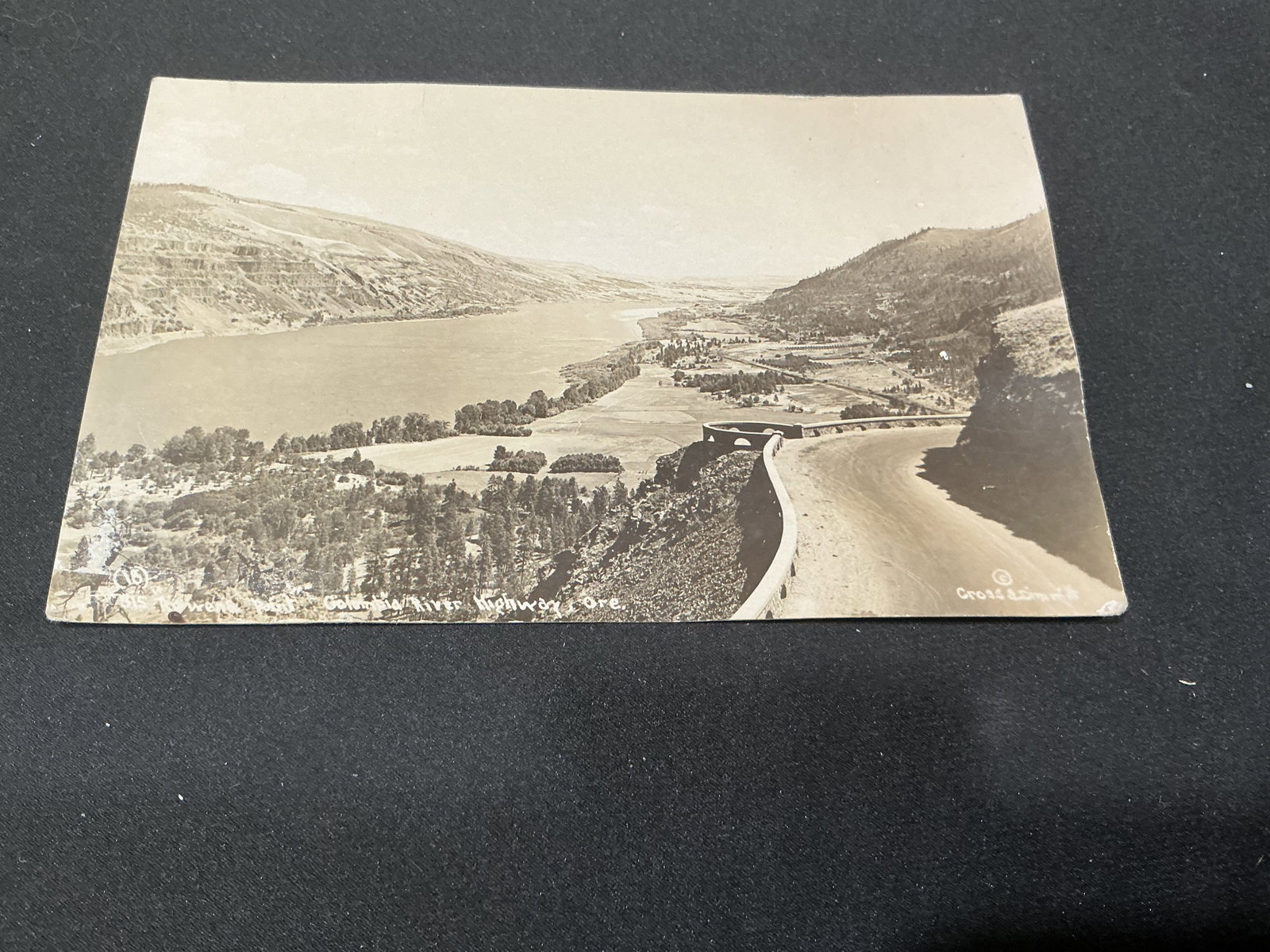 1915 Columbia River Highway Postcard: Vintage real photo postcard depicting the Columbia River Highway in Oregon with scenic overlook and river valley view. Postmarked and mailed in 1915 with a one-cent stamp and handwritten