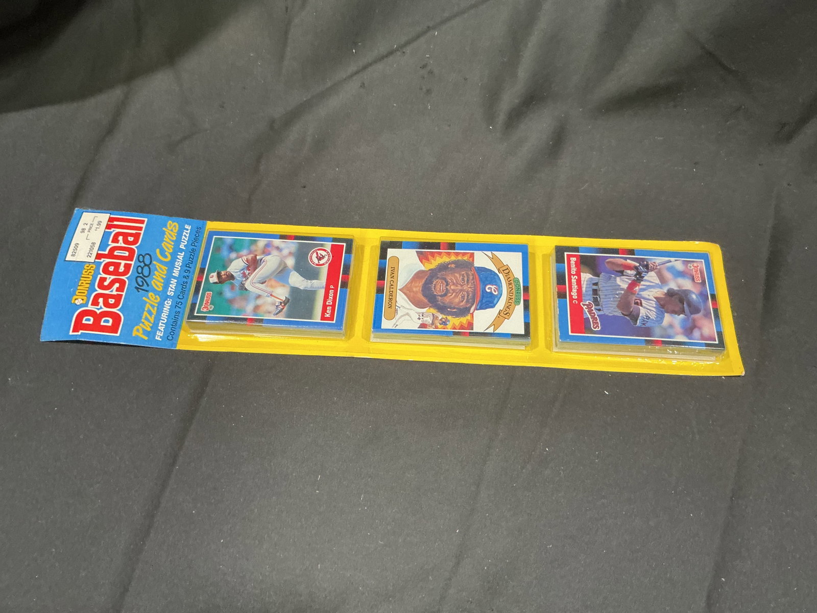 1988 Donruss Puzzle & Cards Pack: Factory sealed 1988 Donruss Baseball Puzzle & Cards pack containing three unopened card sections and Stan Musial puzzle pieces. Visible player cards include Ken Dixon, Tywone Calhoun, and Benito