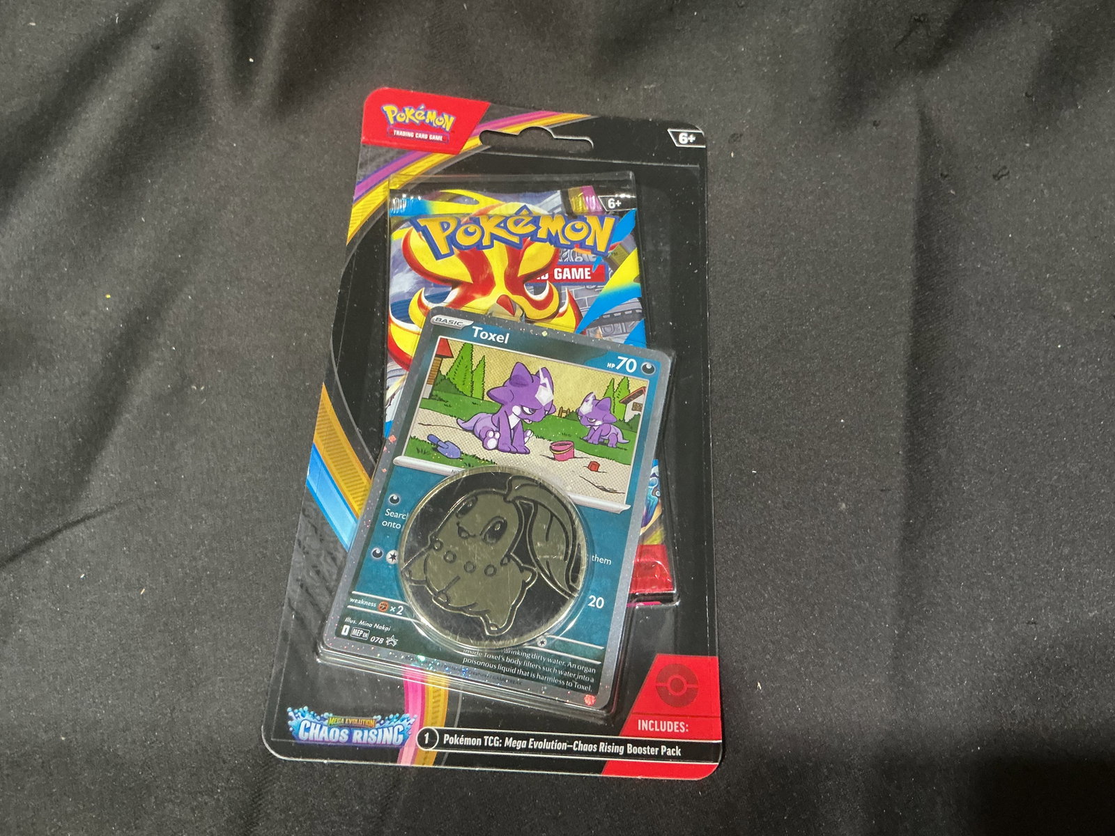 Pokemon Chaos Rising Toxel Blister: A familiar favorite from our previous auction, this factory sealed Pokemon Mega Evolution Chaos Rising checklane blister includes a Chaos Rising booster pack, a Toxel promo card, and a collectible