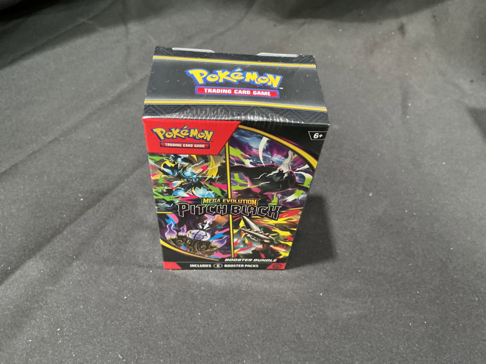 Pitch Black Booster Bundle: Making another appearance in this auction, this factory sealed Pokemon Mega Evolution Pitch Black Booster Bundle contains six booster packs from the Pitch Black expansion. With earlier Pitch Black