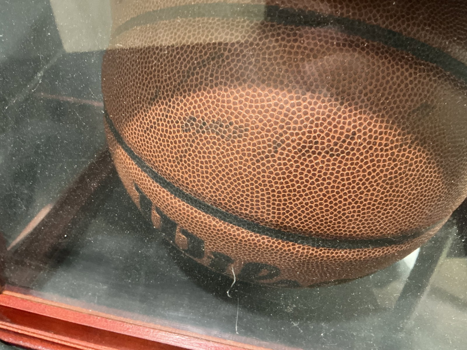 Dominique Wilkins Signed Basketball: Featured again after appearing in our previous auction, this Spalding basketball signed by Hall of Famer Dominique Wilkins is displayed in a wood-framed glass display case. The visible autograph,