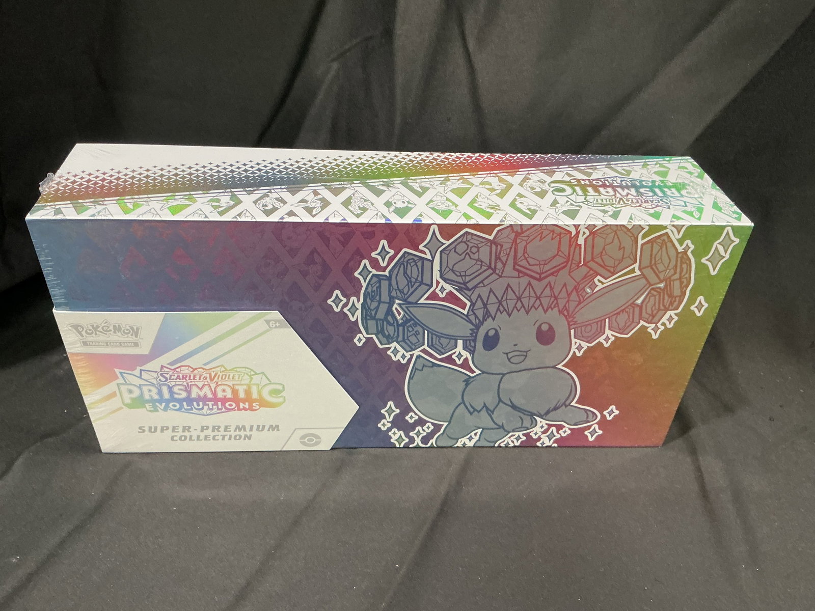 Prismatic Evolutions Super Premium Box: Featured again after drawing substantial viewing interest in its previous appearance, this factory sealed Pokemon Scarlet & Violet Prismatic Evolutions Super Premium Collection features Eevee-themed