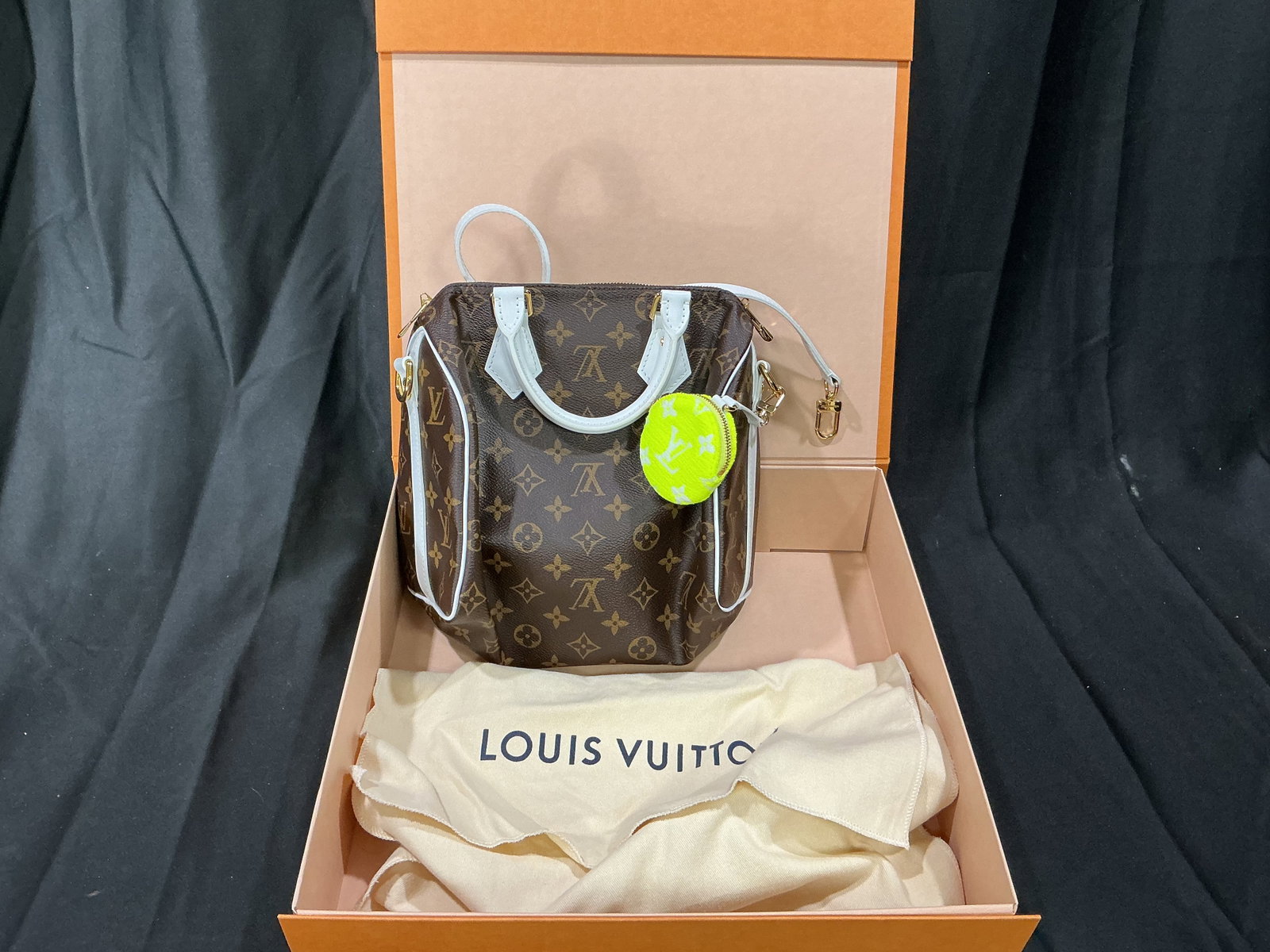 Louis Vuitton Monogram Canvas Handbag with Original Box, Dust Bag & Lock: Featured again, this elegant Louis Vuitton handbag is crafted in the brand's iconic Monogram coated canvas with smooth white leather trim and gold-tone hardware. It features a structured silhouette,