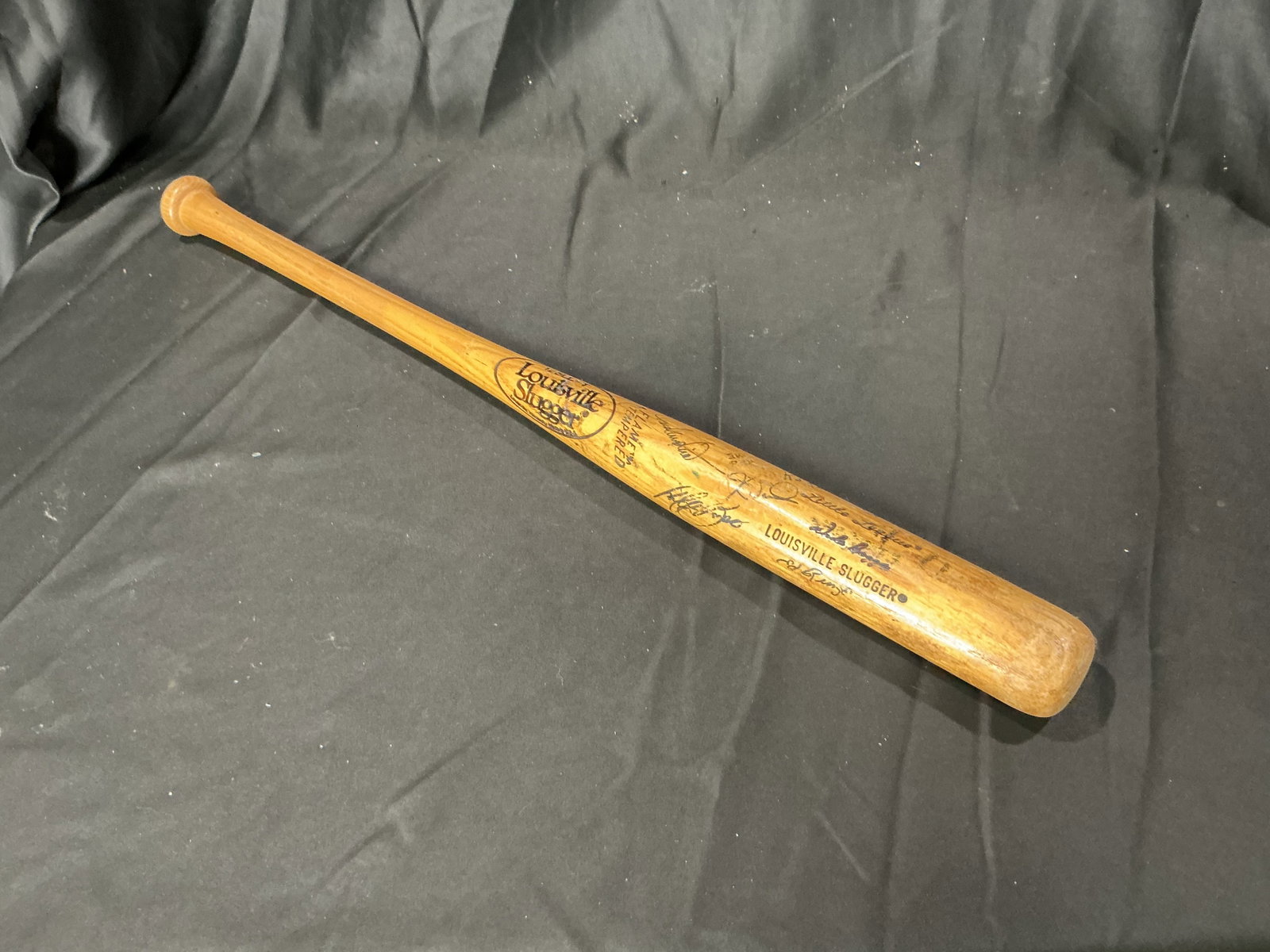 Vintage Louisville Slugger "Little League" 125LLFT Signed Bat: Back in the lineup, this vintage Louisville Slugger wooden bat is marked "Little League" and "125LLFT" (flame tempered) and bears numerous handwritten player/autograph-style signatures in pen. The