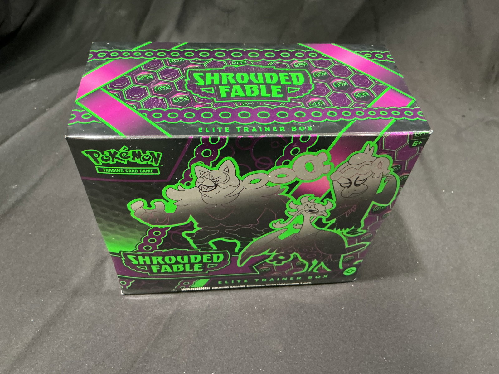Pokemon Shrouded Fable ETB: Back for another appearance, this factory sealed Pokemon Scarlet & Violet Shrouded Fable Elite Trainer Box includes booster packs, a full-art Pecharunt promo card, sleeves, dice, and other collector a
