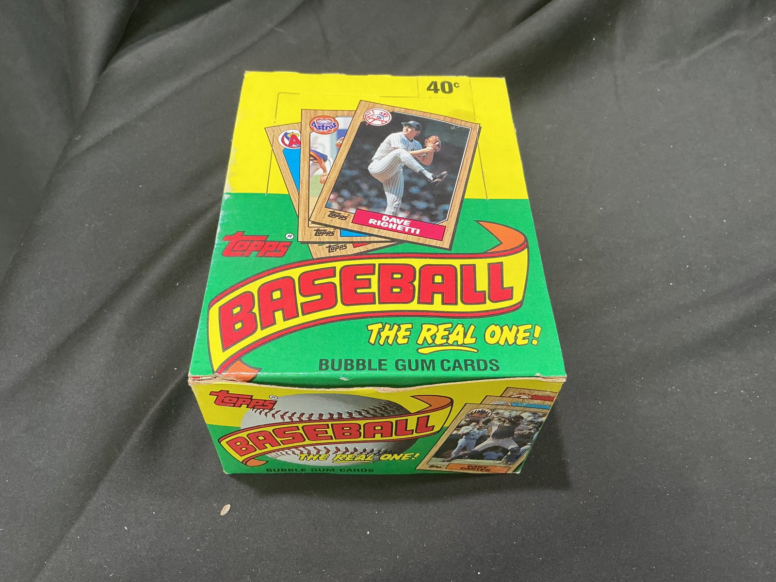 1987 Topps Baseball Wax Box 36 Packs: Back in the auction, this 1987 Topps Baseball display box contains 36 unopened wax packs with bubble gum. A recognizable vintage baseball card release offering another chance at stars, rookies, and