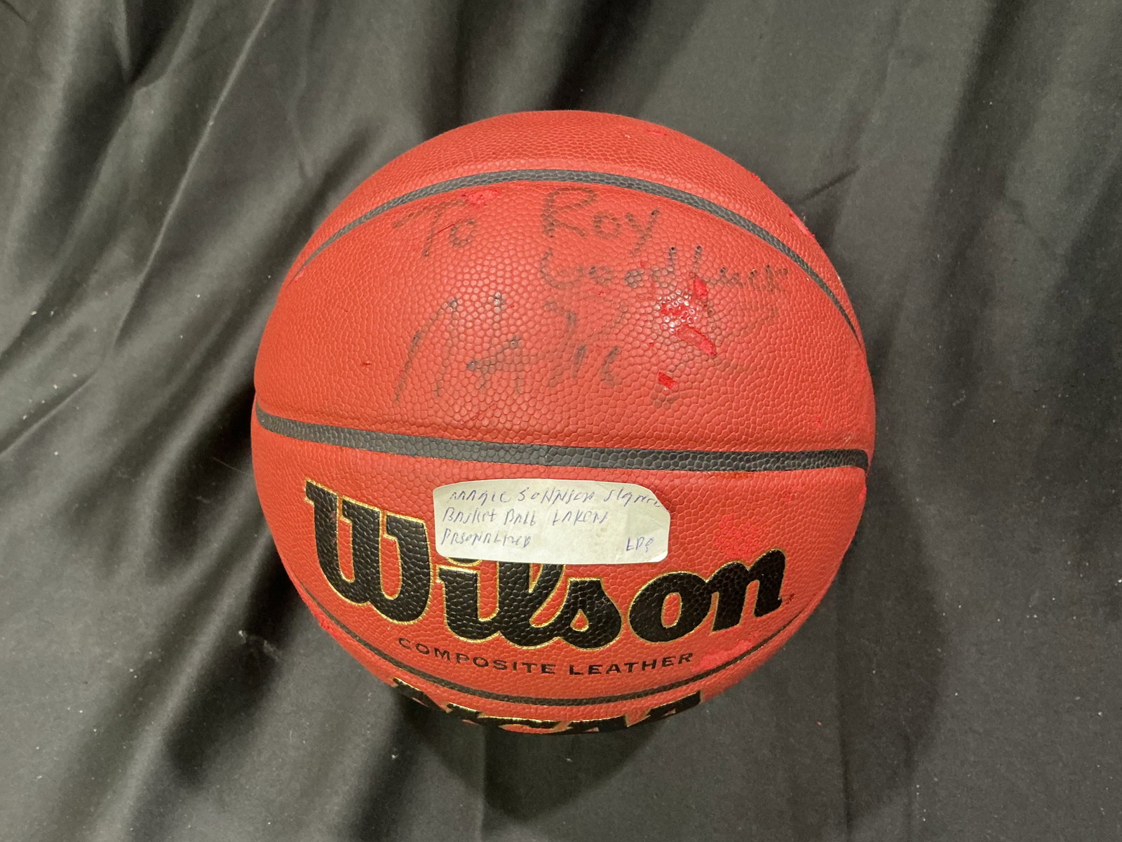 Magic Johnson Signed NCAA Basketball: Offered once more, this Magic Johnson autographed Wilson NCAA composite leather basketball is signed with the inscription "To Roy, Good Luck." An attractive display piece honoring one of basketball's