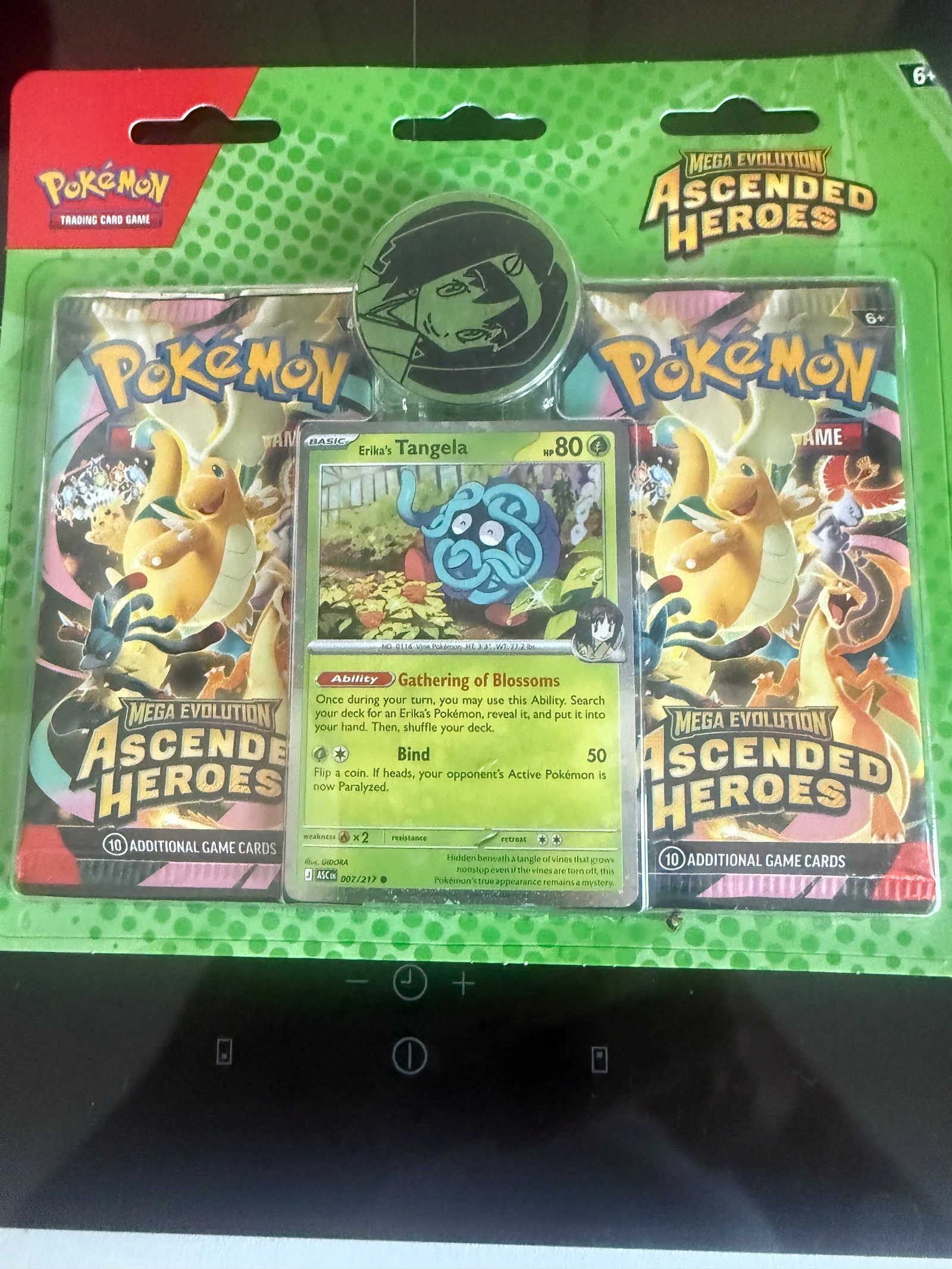 Erika's Tangela Ascended Heroes Blister: Making another appearance, this factory sealed Pokemon Mega Evolution Ascended Heroes blister pack includes two Ascended Heroes booster packs, an Erika's Tangela foil promo card, and an Erika