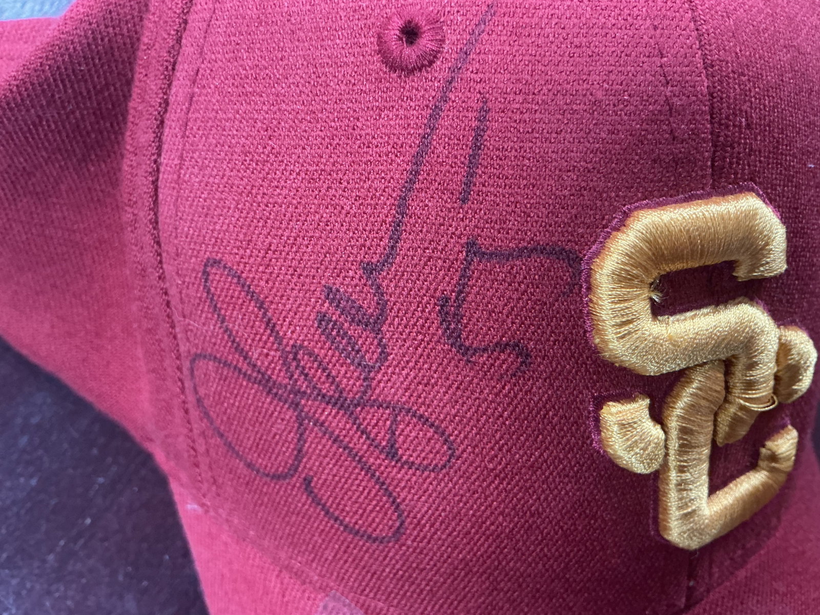 Autographed USC Trojans Baseball Cap By Junior Seau: Featured again, this USC Trojans cardinal red baseball cap features an embroidered interlocking 'SC' logo in gold and is signed on the front panel in black marker by Junior Seau. A distinctive USC