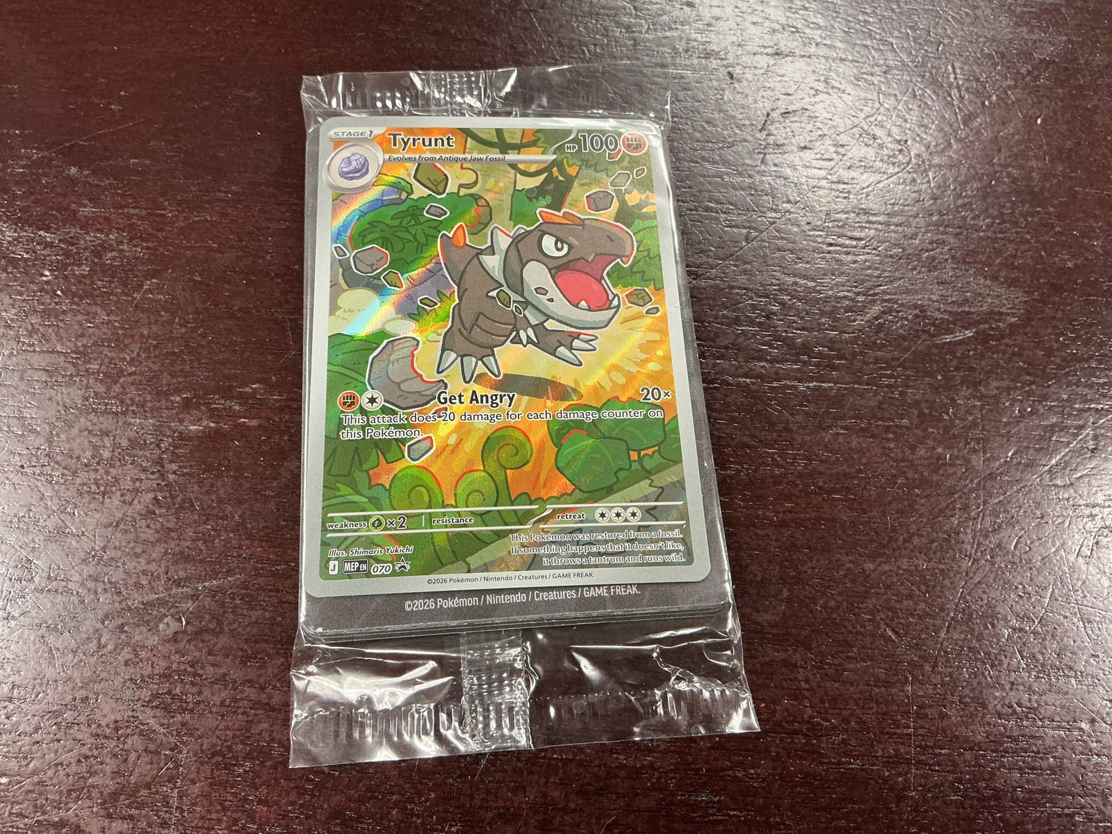 Pokemon Tyrunt Sealed Promo Pack: Still sealed in its original clear wrapper, this Pokemon promotional card pack showcases a Tyrunt promo card from the Mega Evolution Perfect Order release. The remaining contents are concealed within