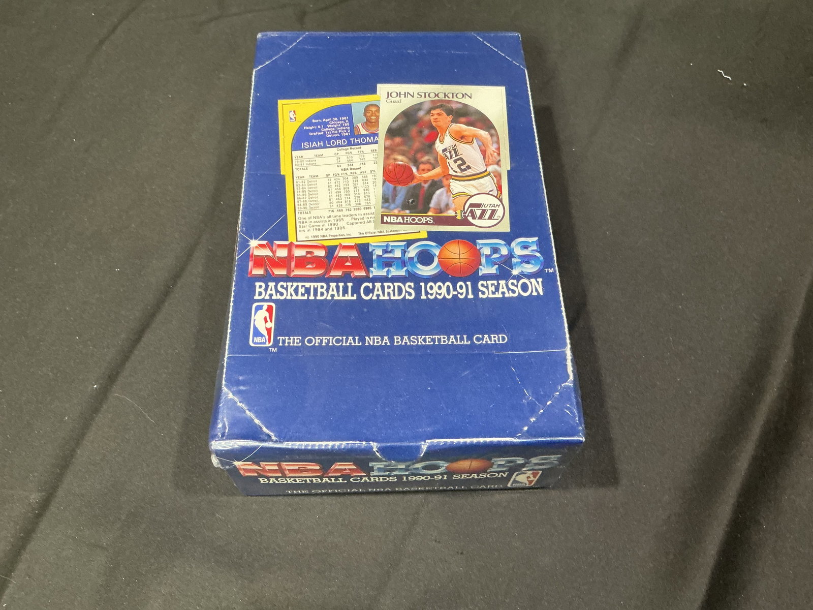1990-91 NBA Hoops Basketball Cards Wax Pack Box: Another early-1990s basketball card offering, this 1990-91 NBA Hoops wax pack box features stars including Michael Jordan, Magic Johnson, Larry Bird, John Stockton, and others. The box appears opened