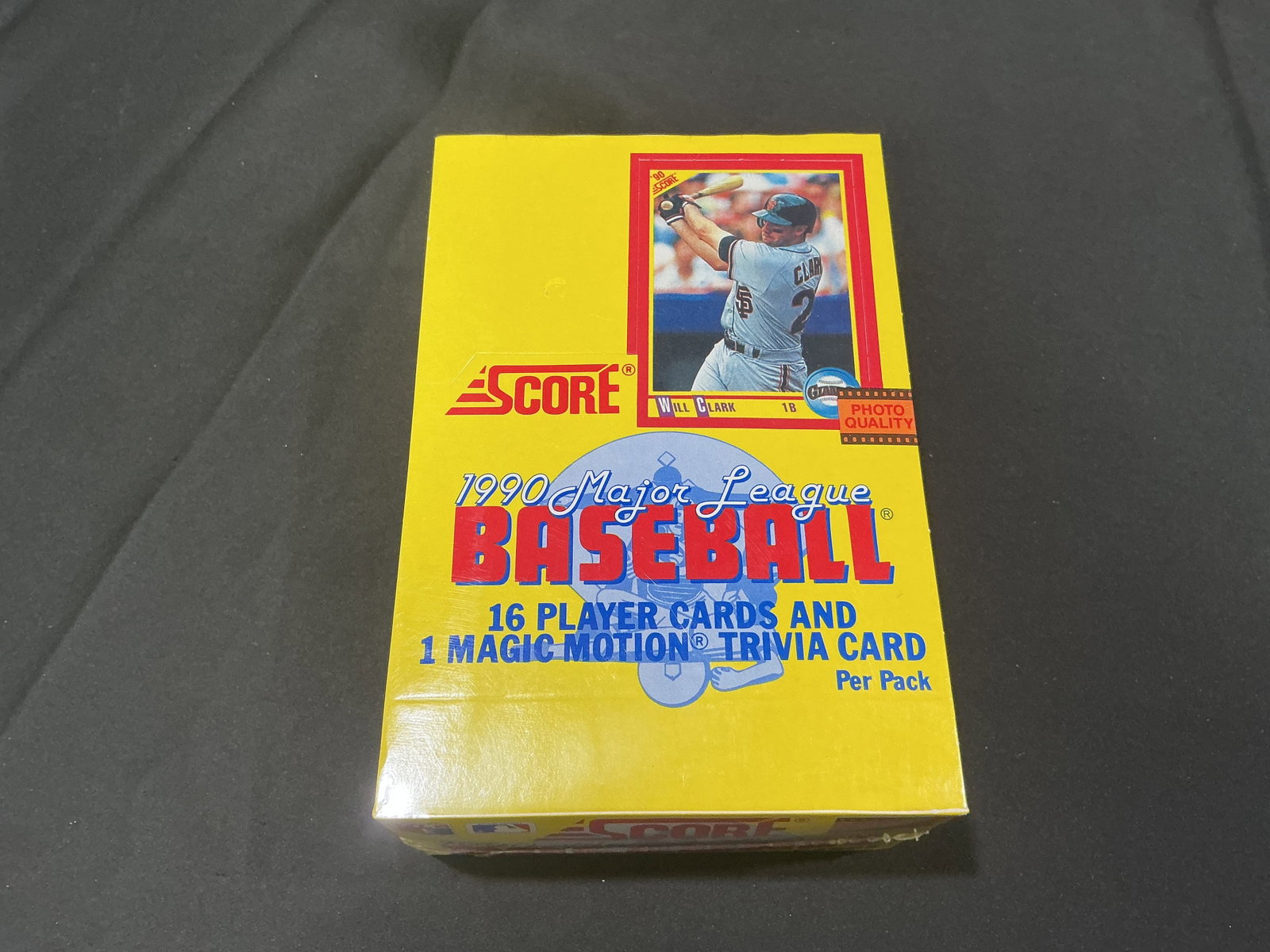 1990 Score Major League Baseball Factory Sealed Card Box: Still unopened in its original factory wrap, this 1990 Score Major League Baseball trading card box features the bright yellow retail design with Will Clark on the cover. Packs from the release