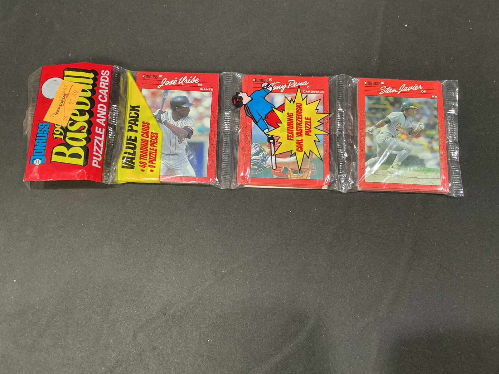 1990 Donruss Baseball Value Pack 48 Cards: Offered once more, this vintage 1990 Donruss Baseball value pack contains 48 trading cards plus nine puzzle pieces. Visible cards include Jose Uribe, Tony Pena with a Carl Yastrzemski puzzle piece,